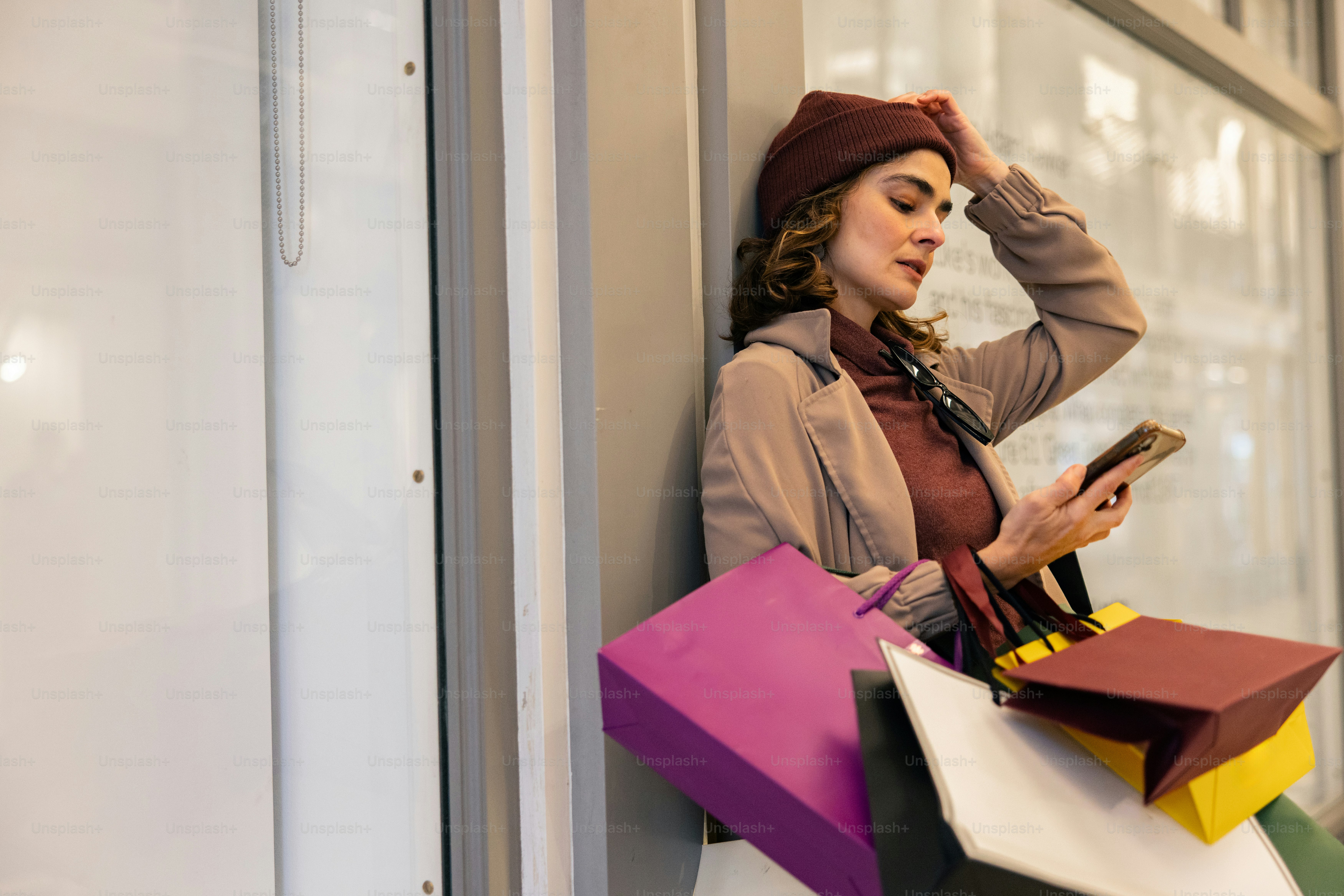 Woman with shopping bags checking her phone