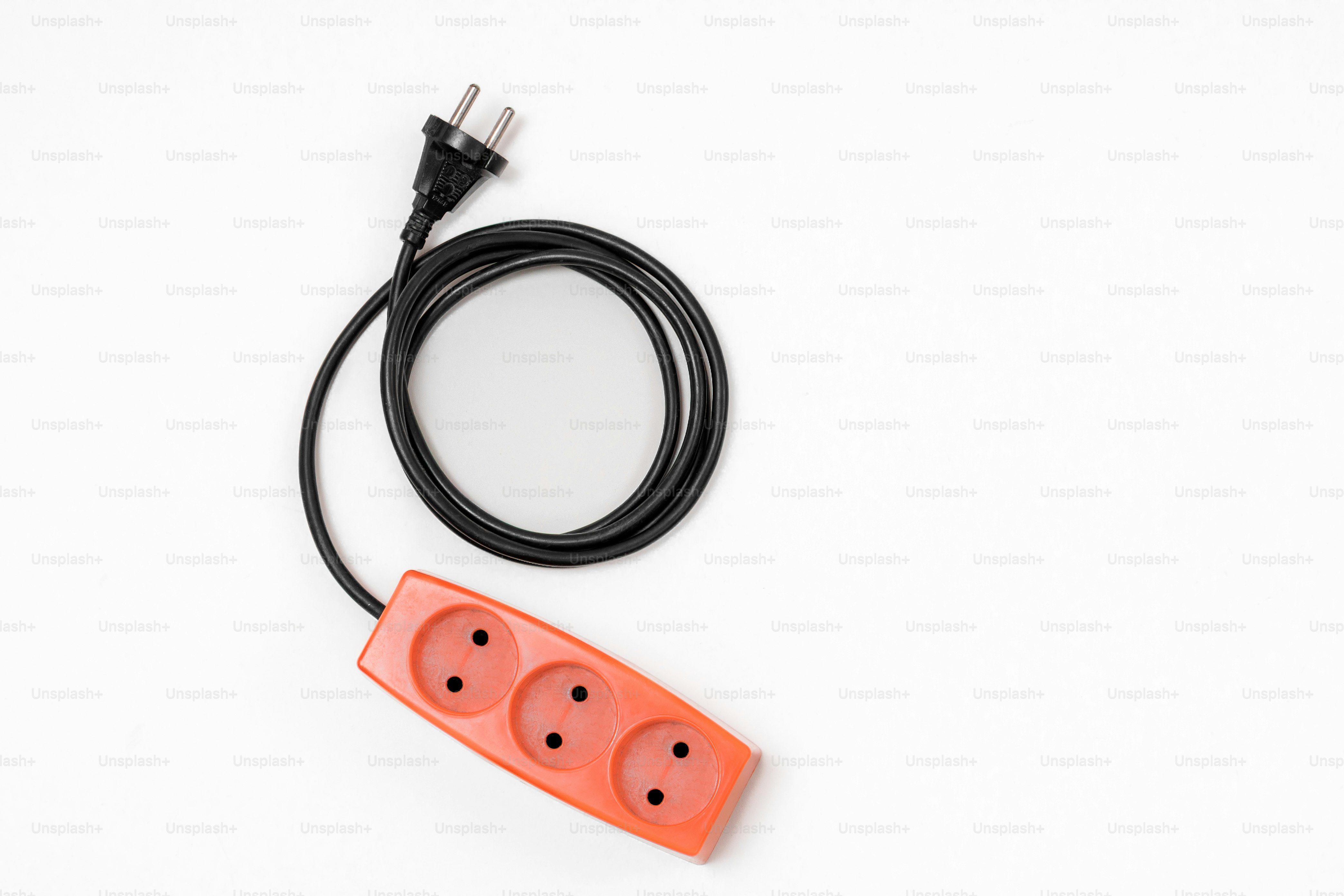 Orange power strip with black cord on white background