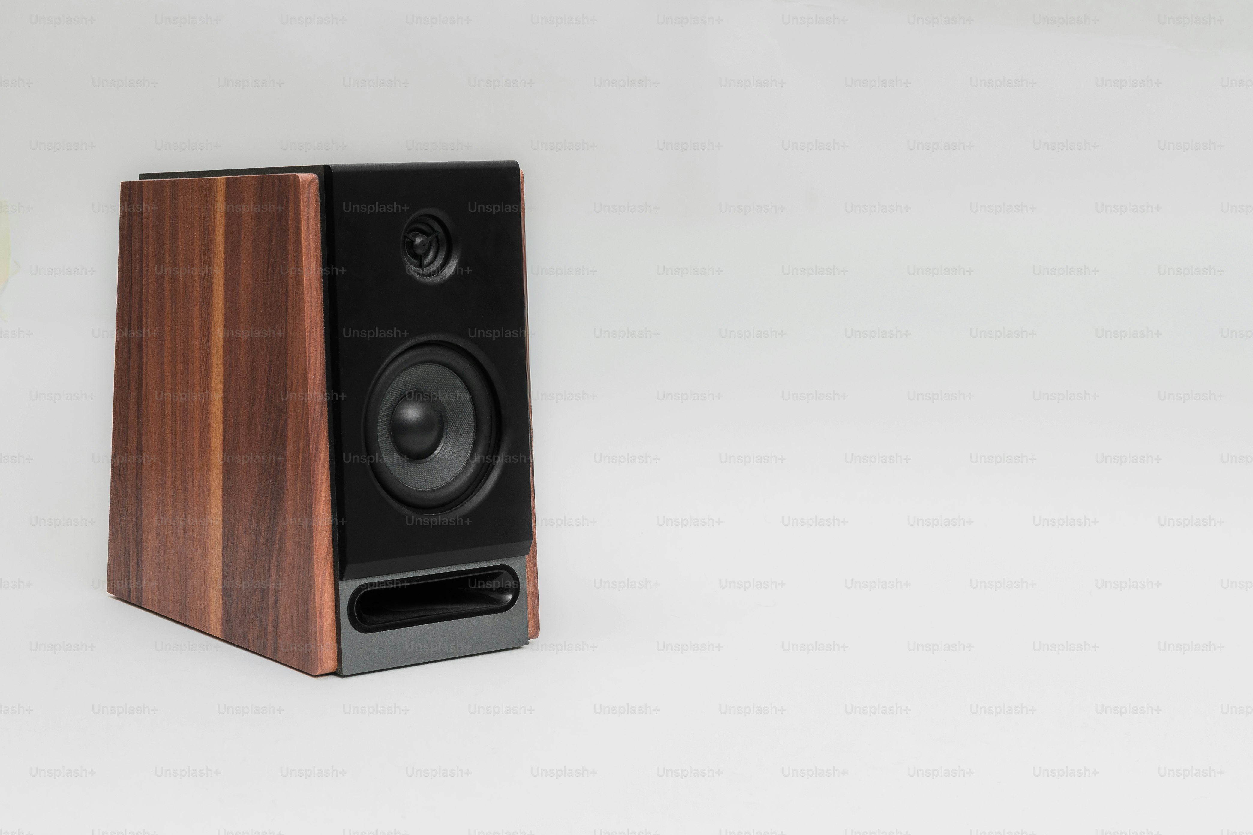 A wooden speaker with a black front panel.