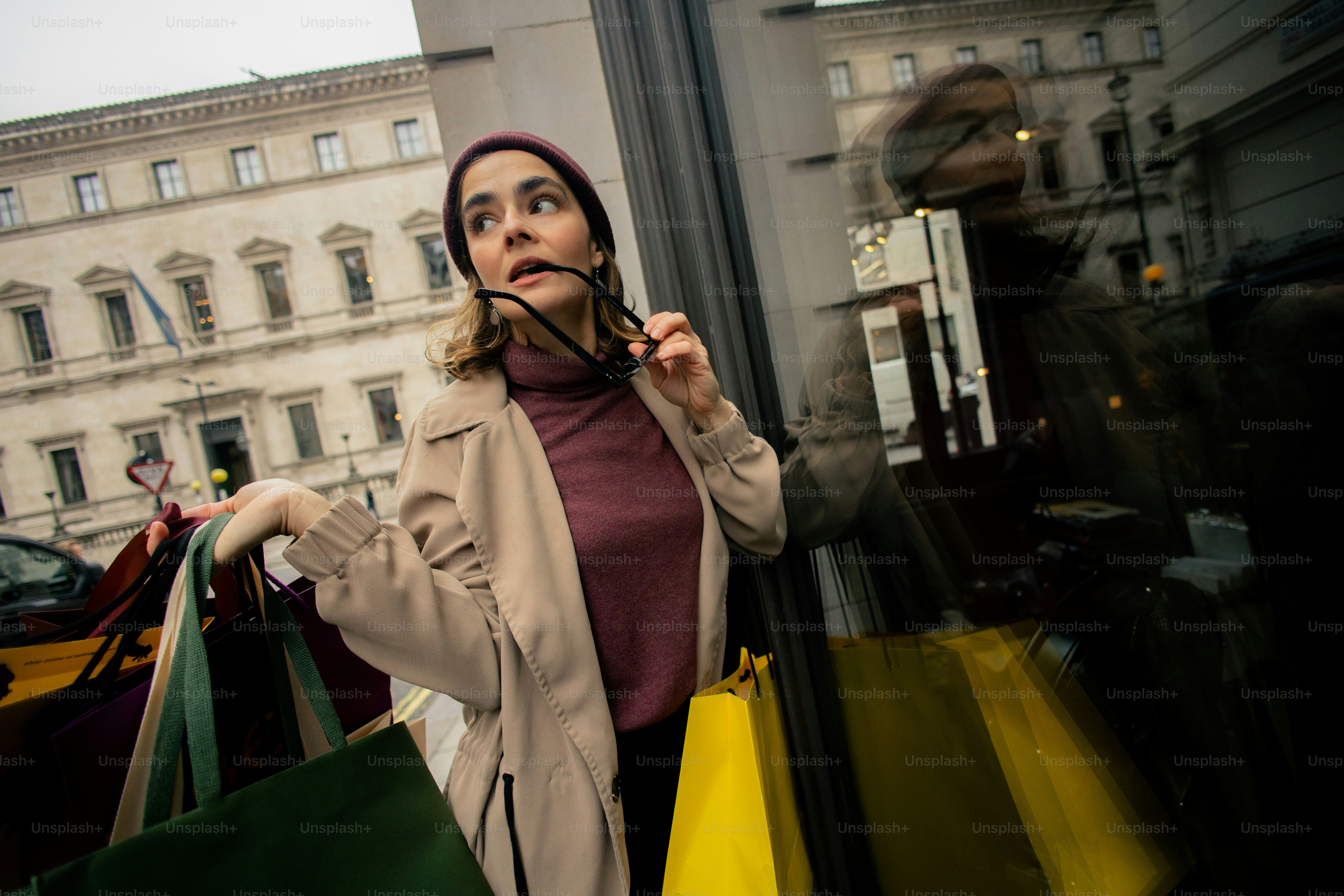 Woman with shopping bags looking into window