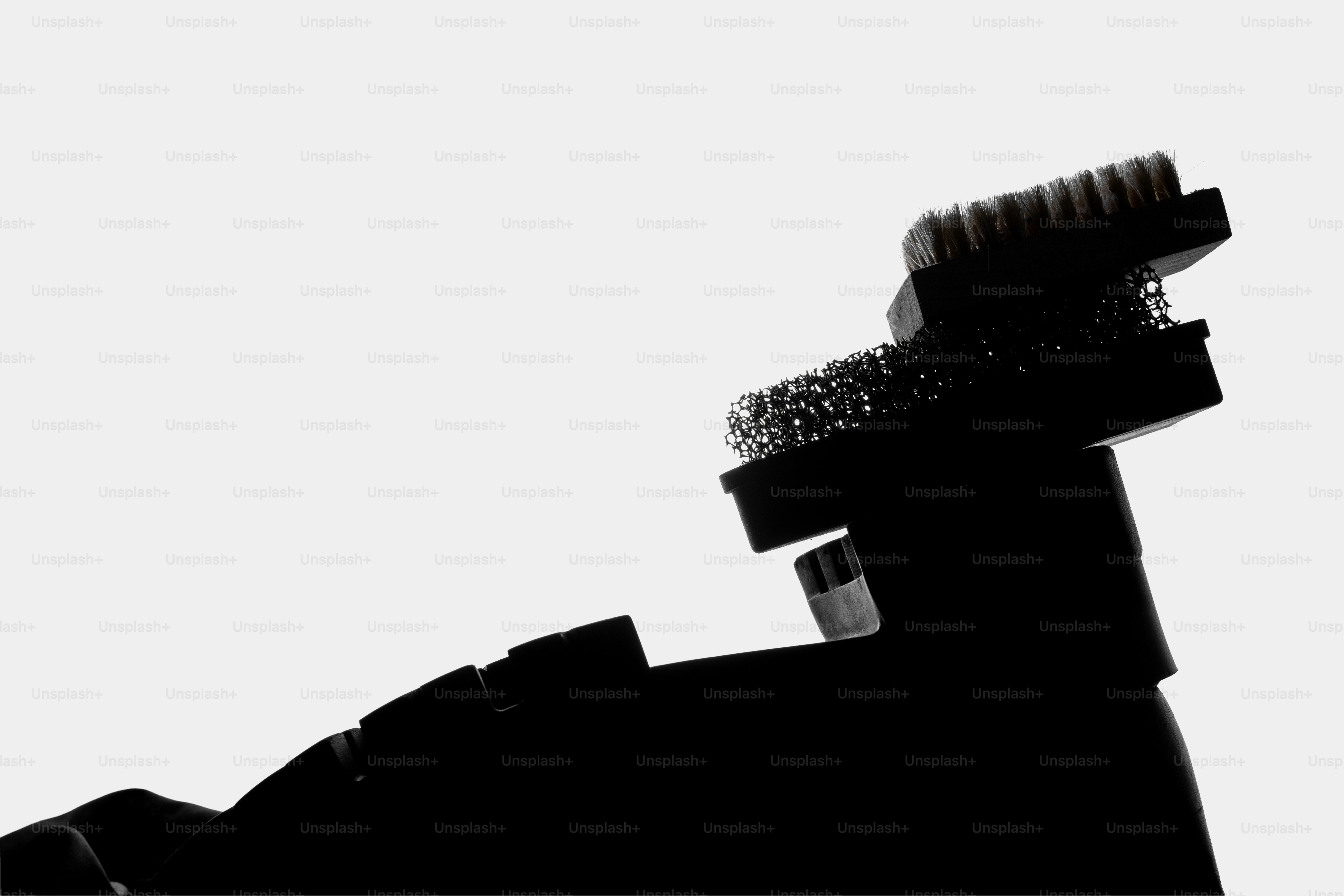 Close-up silhouette of a camera flash unit with lens attachment