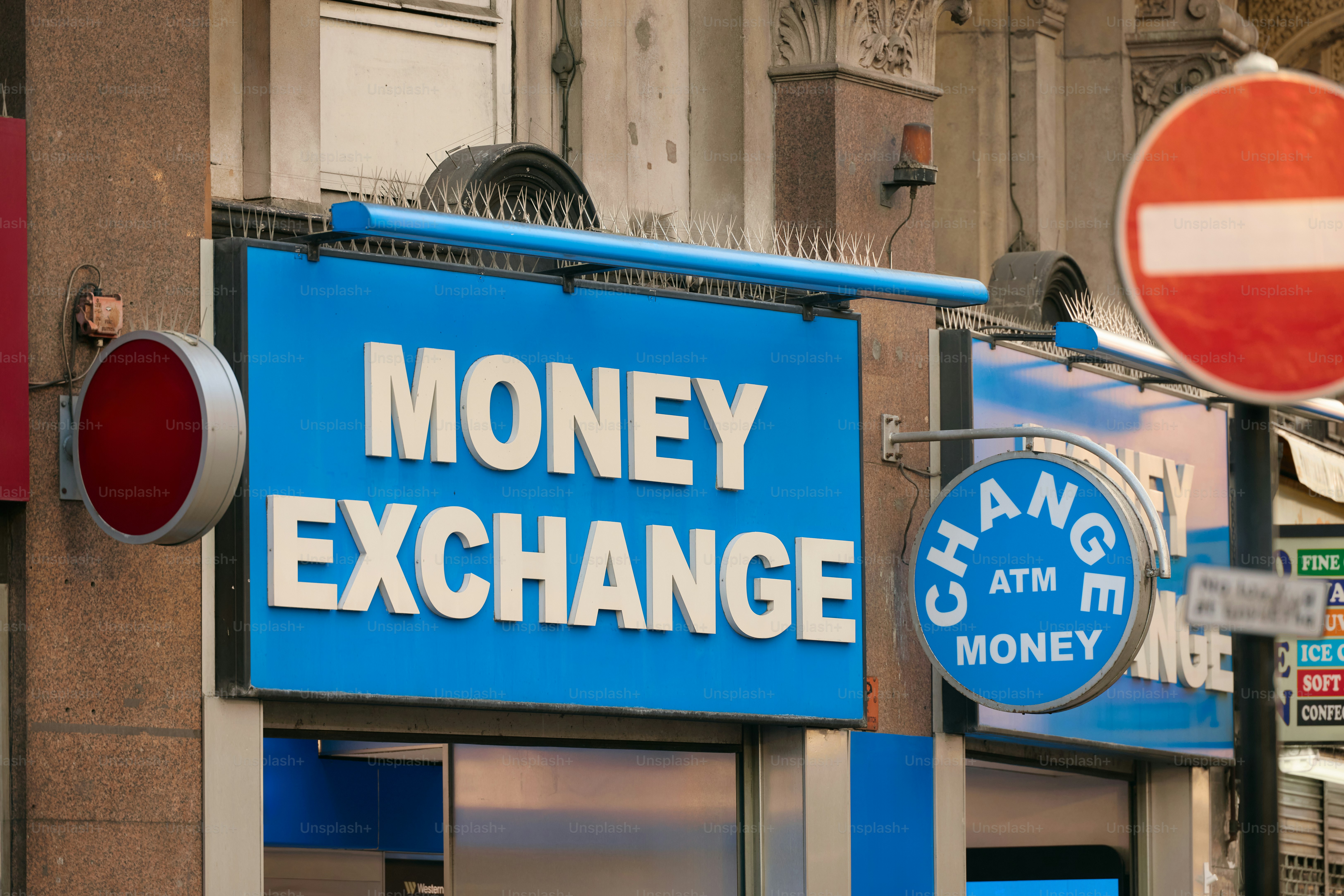 Money exchange sign with atm and red circle sign.