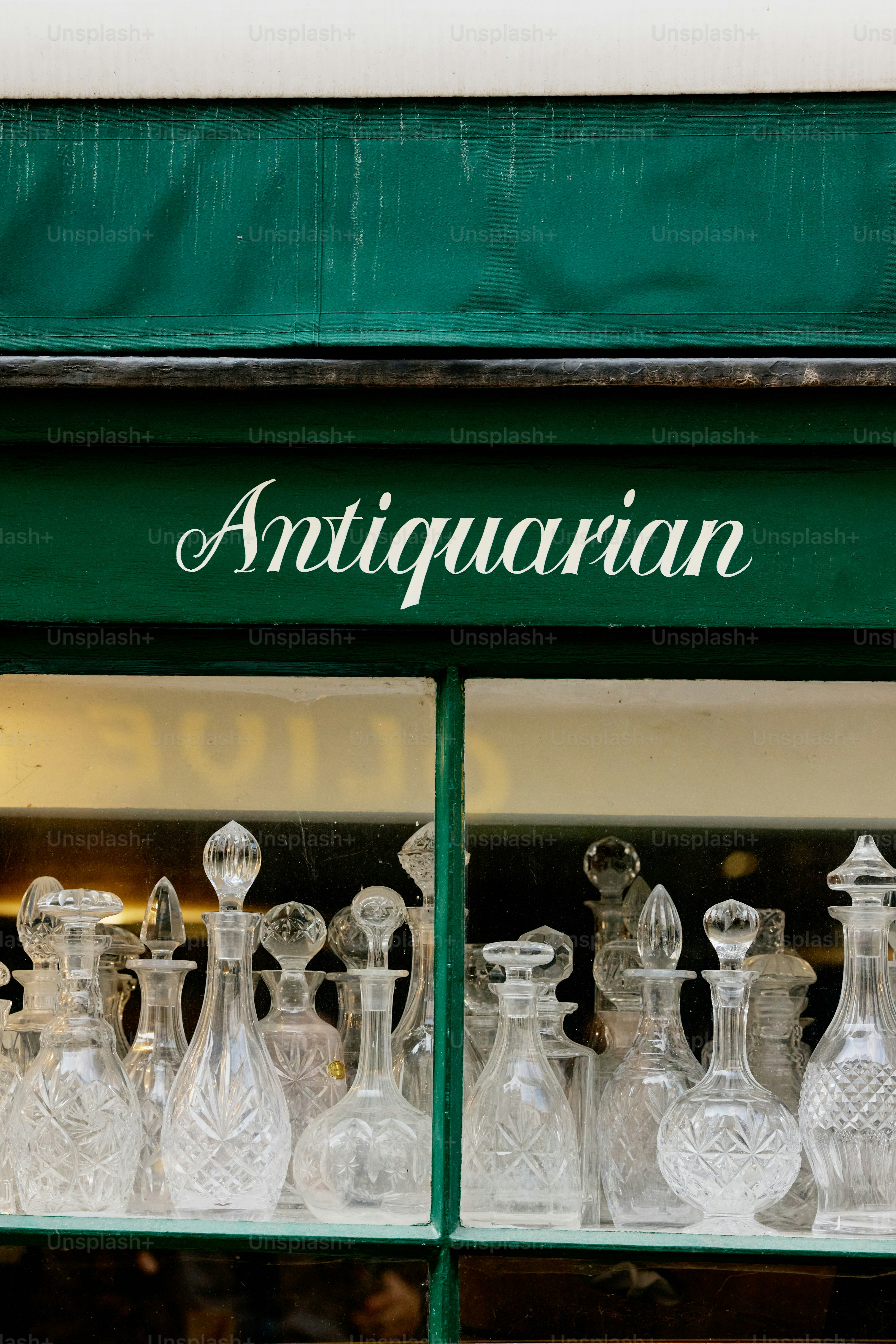 Antique glass bottles displayed in shop window
