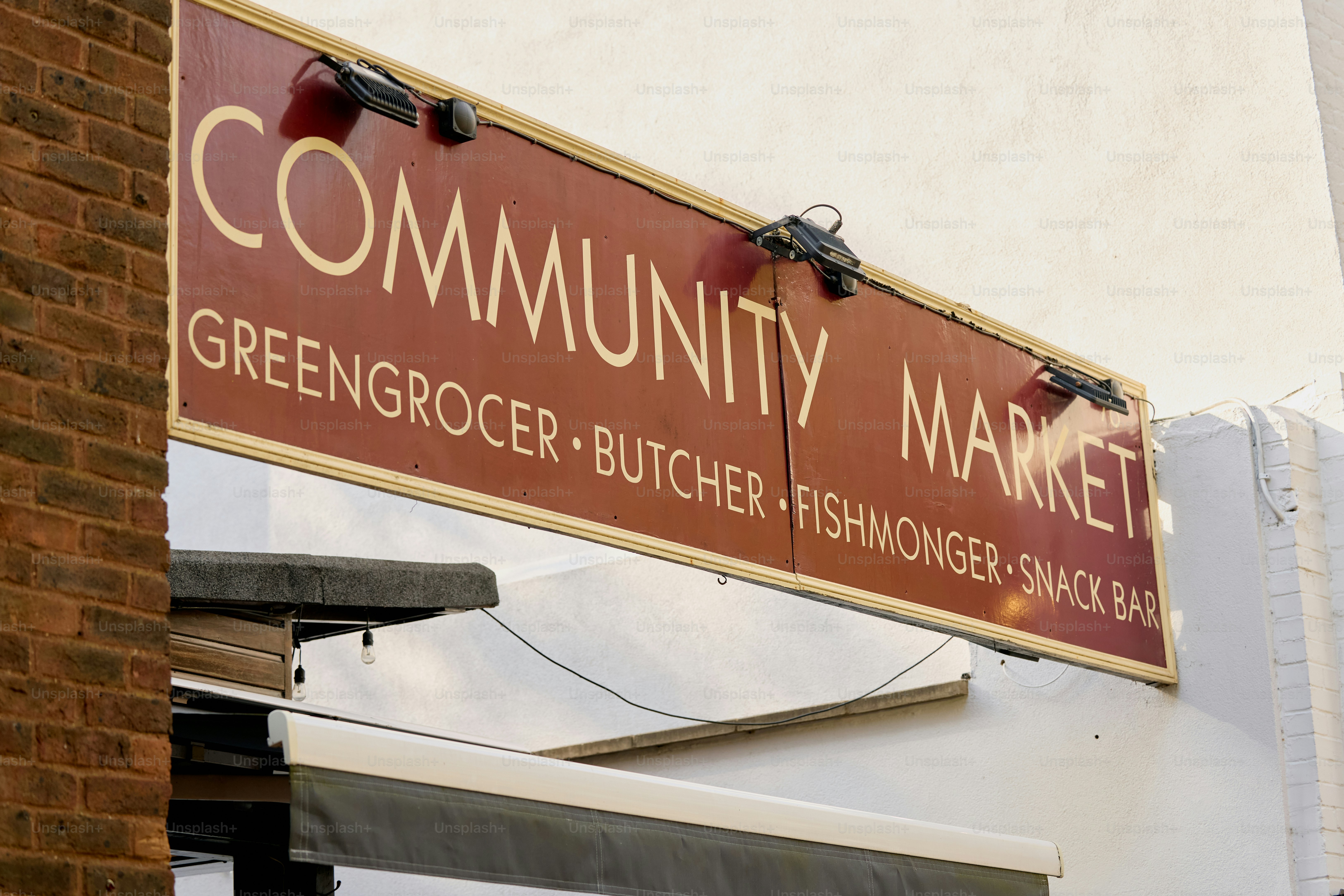 Community market sign with greengrocer, butcher, fishmonger