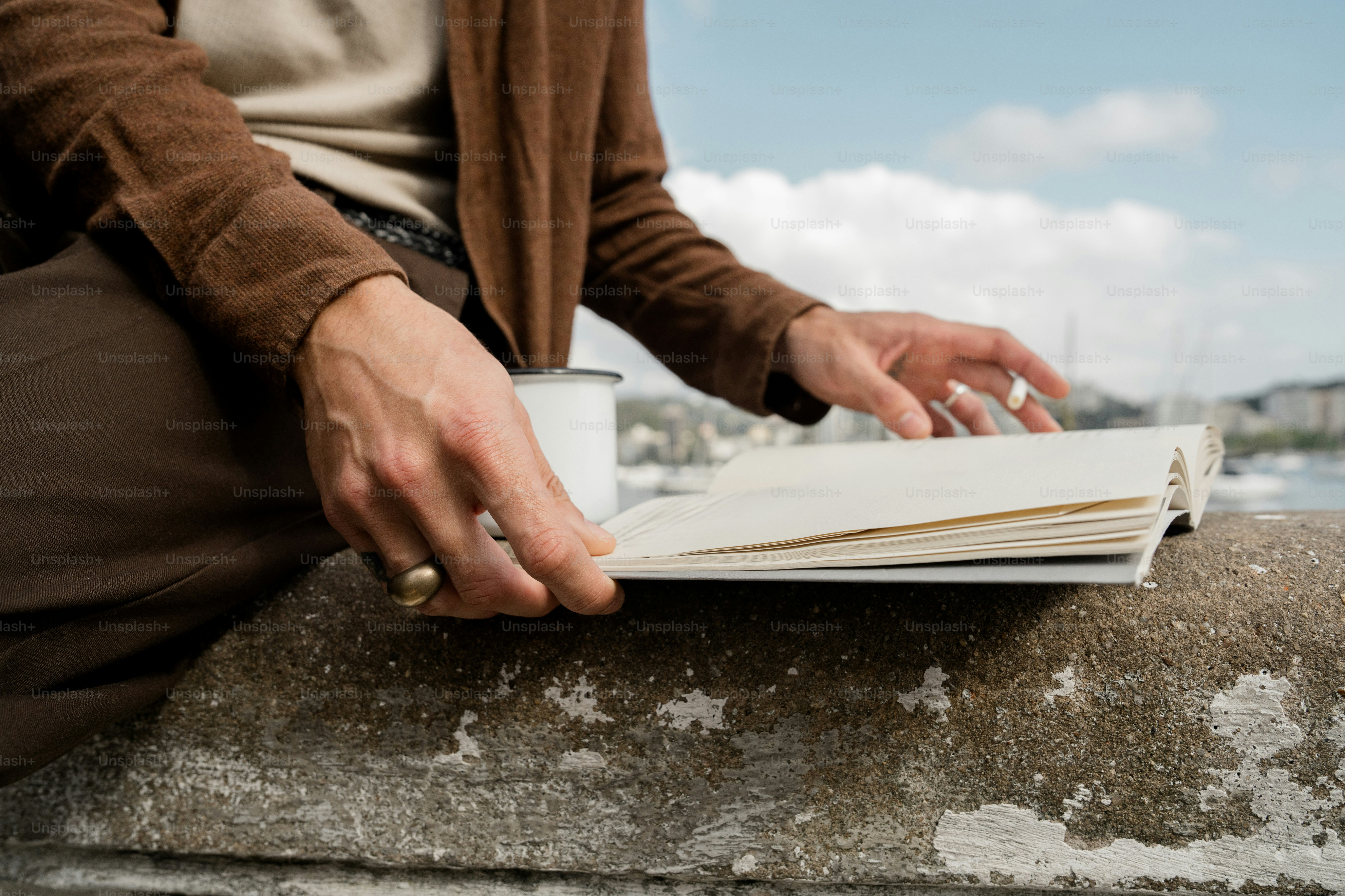 Person reading a book outdoors by the water. photo – Reading Image on ...