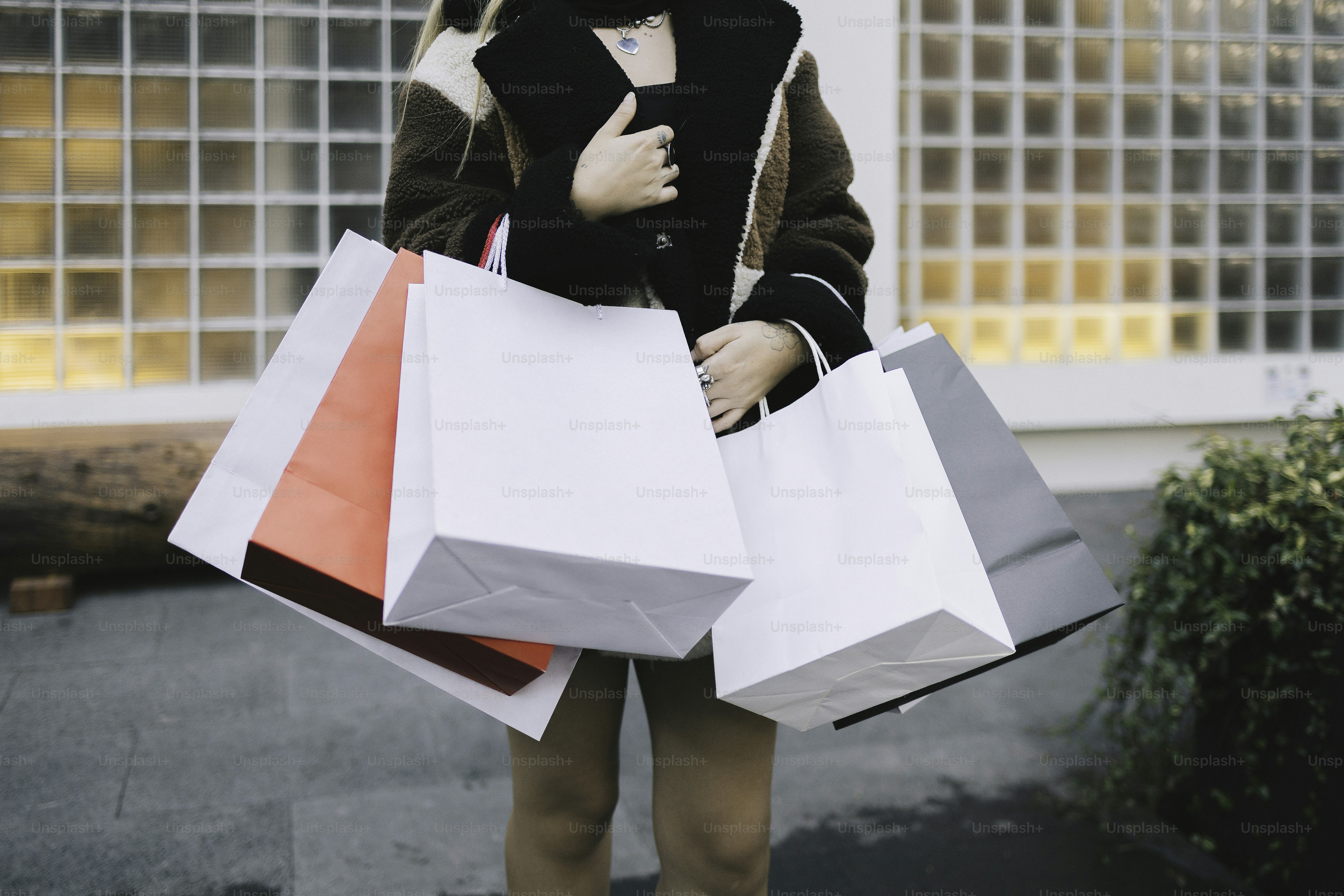 Person holding several shopping bags