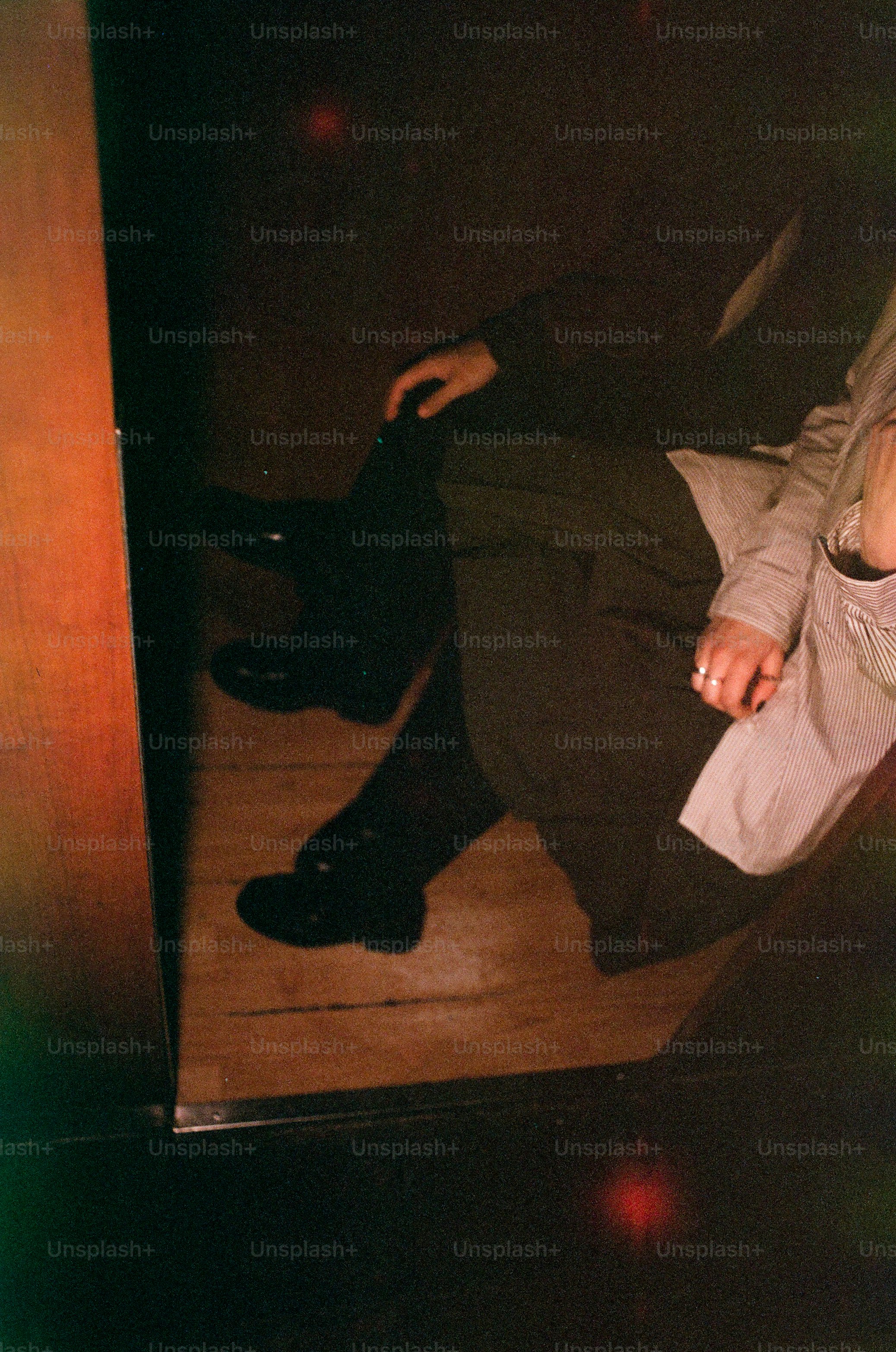 Two people sitting together on wooden floor.