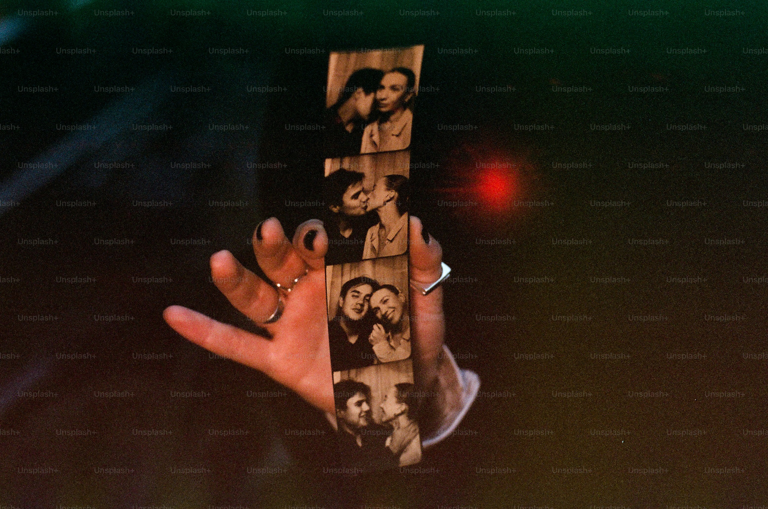 Hand holding vintage couple photos