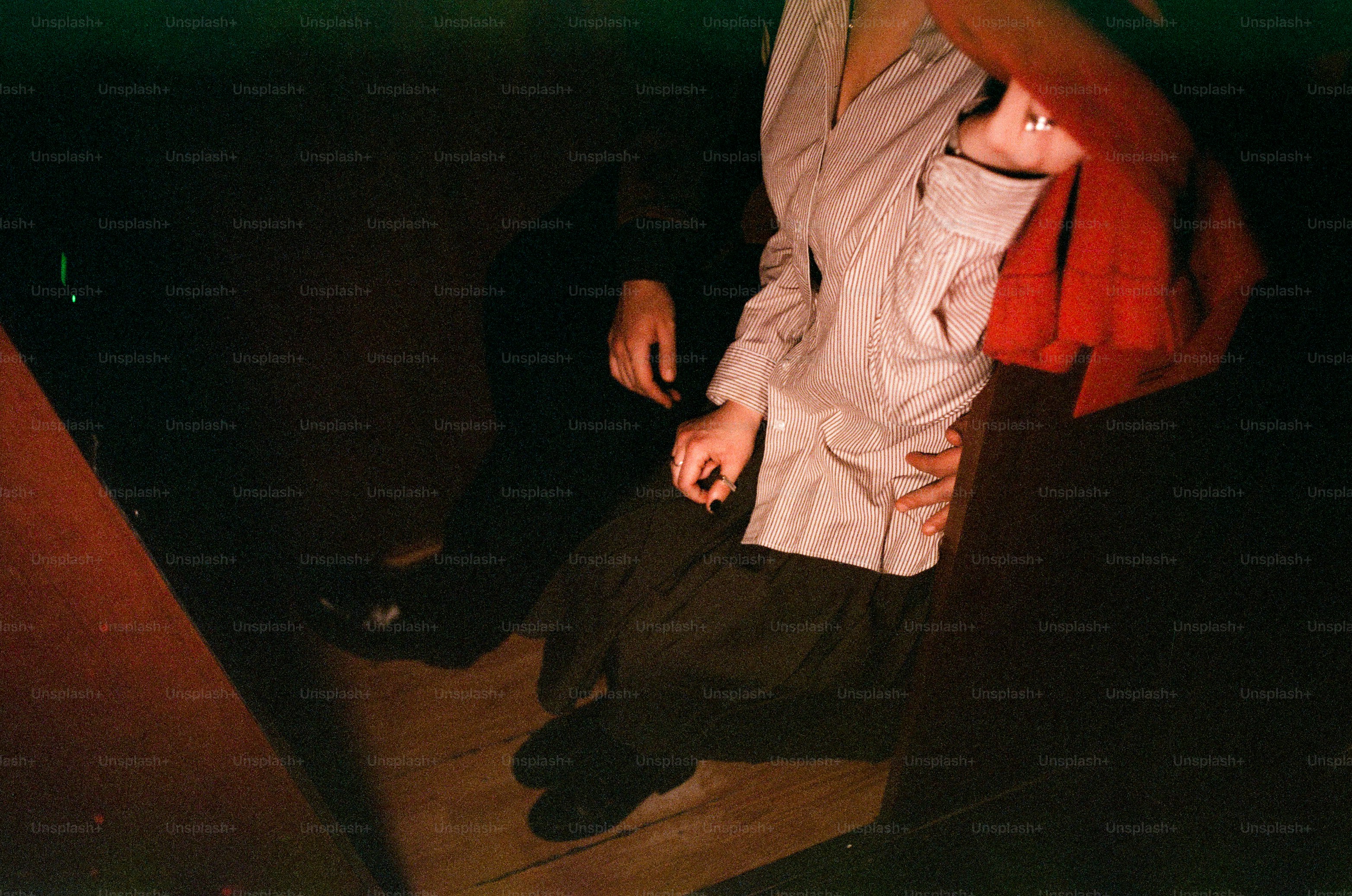 Two people in dimly lit room