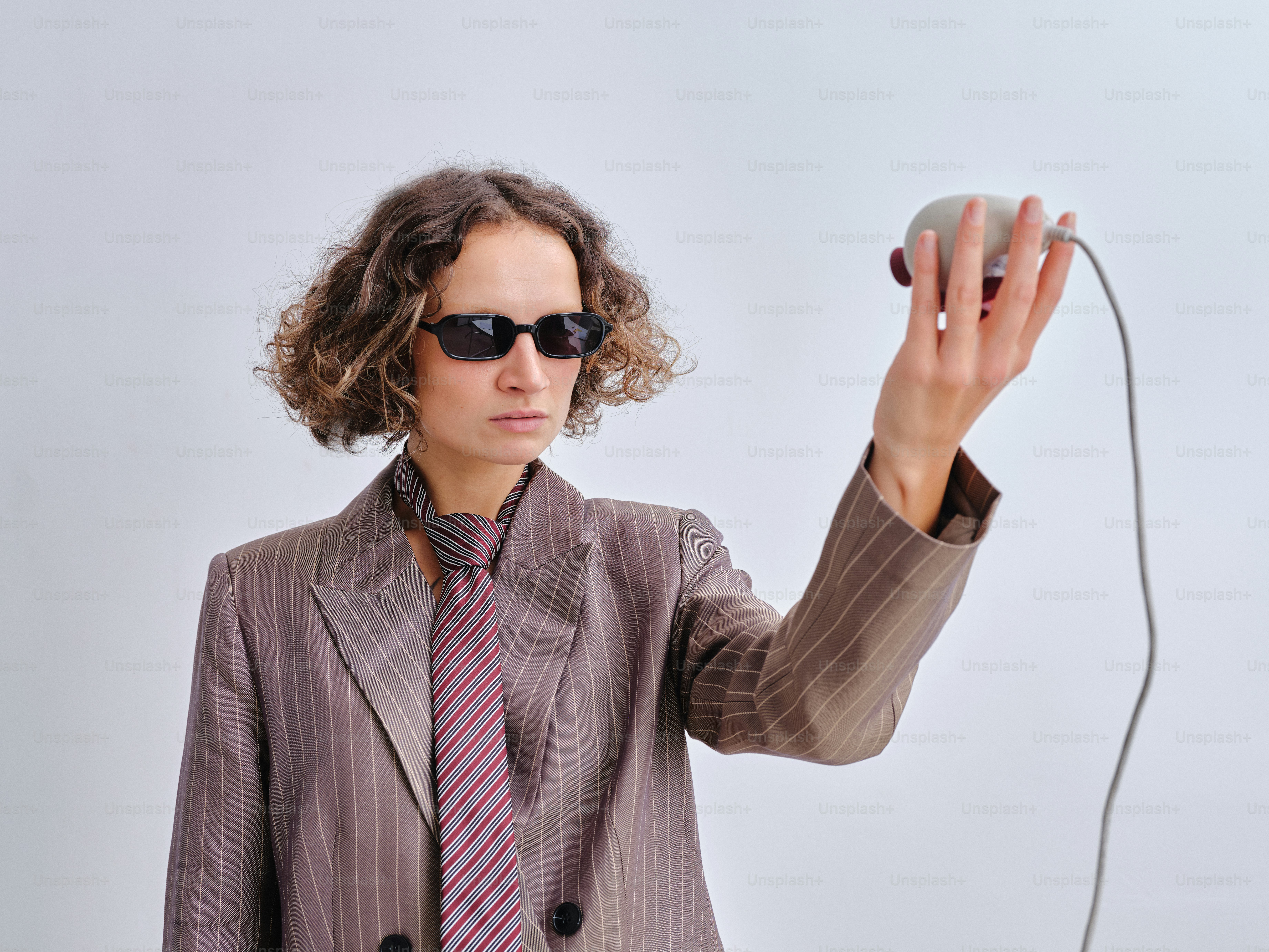 Woman in suit holding a computer mouse photo – Fashion Image on Unsplash