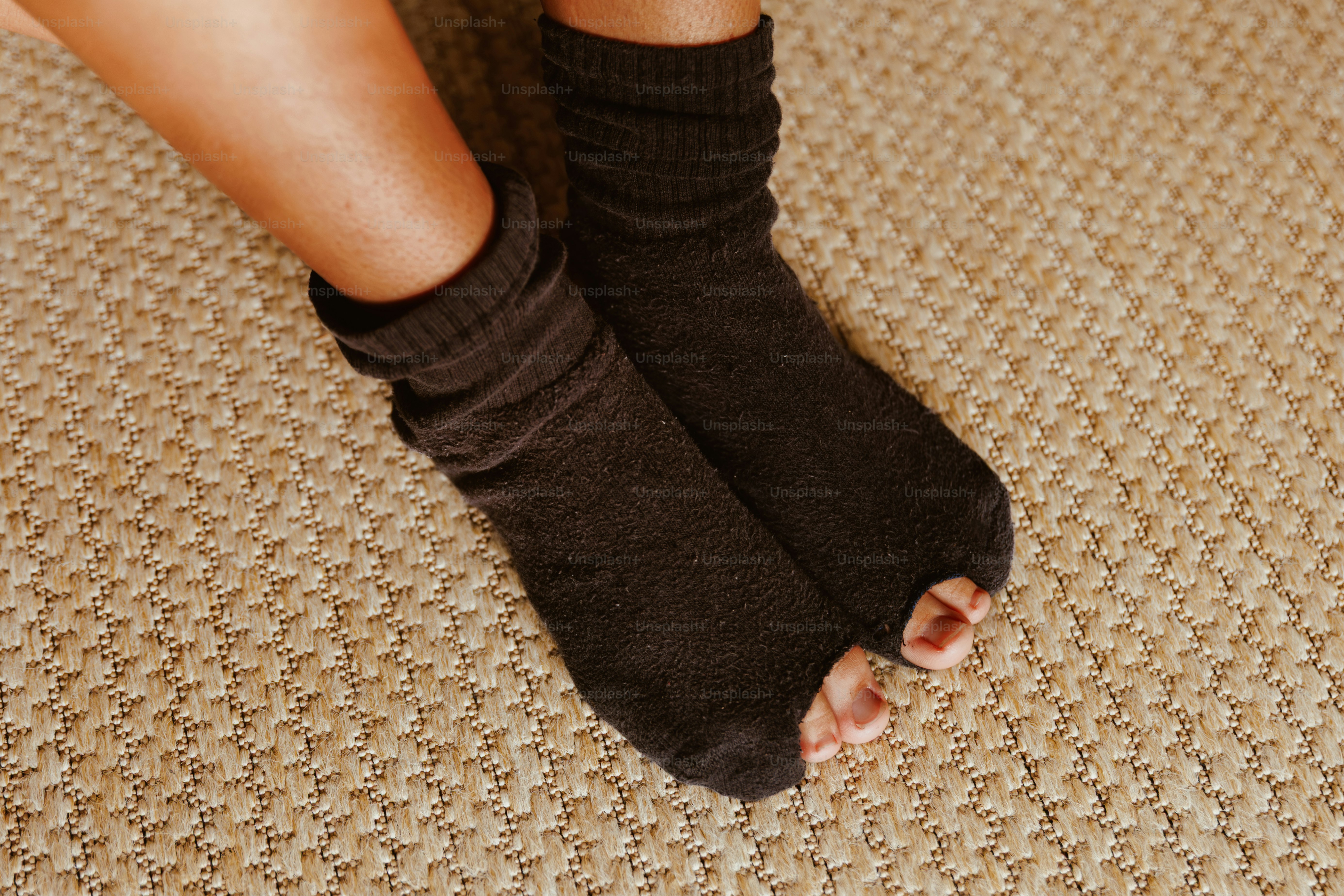 Feet wearing brown toe-less socks on carpet. photo – Recession Image on ...