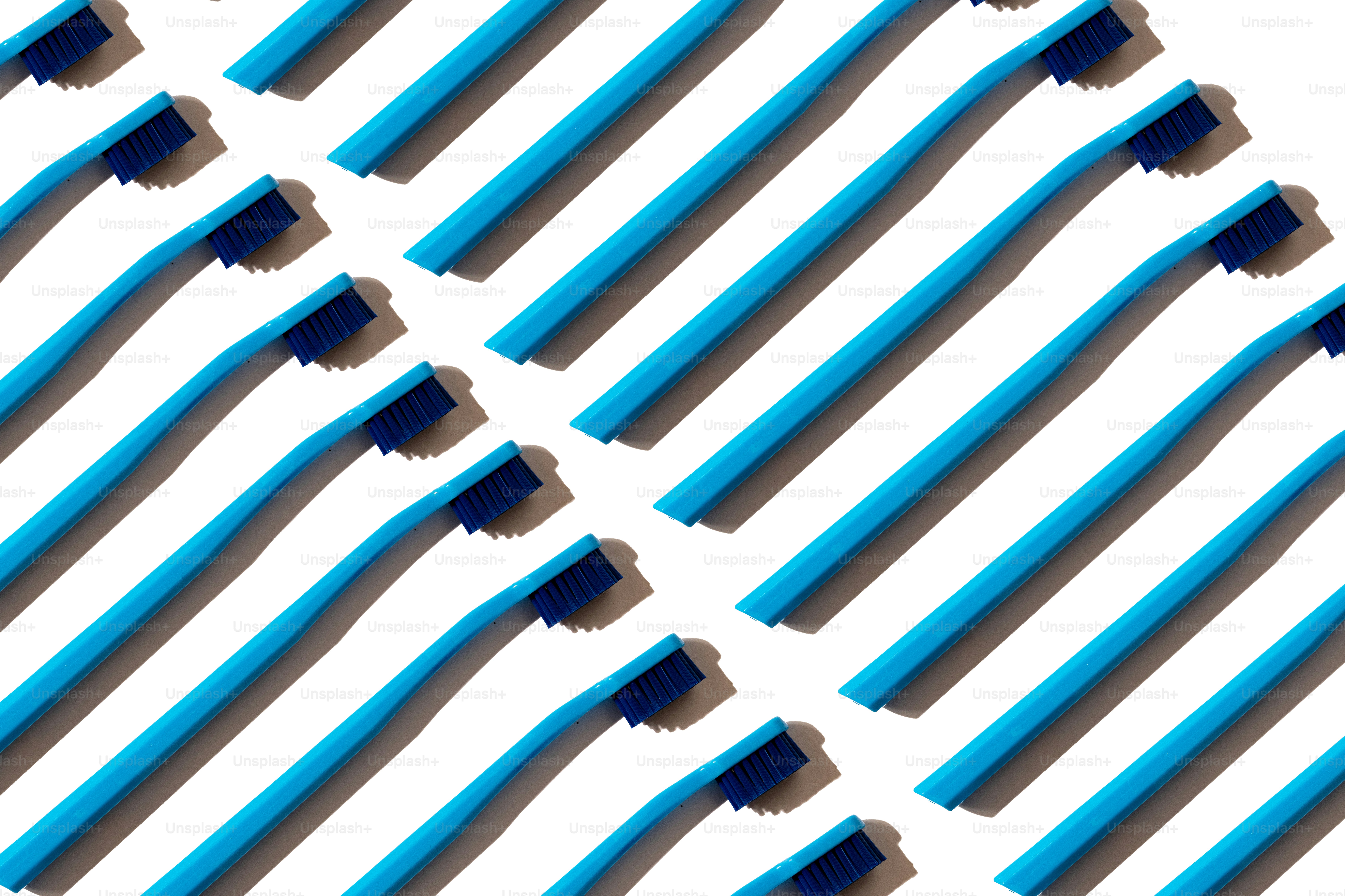 Pattern of blue toothbrushes on a white background