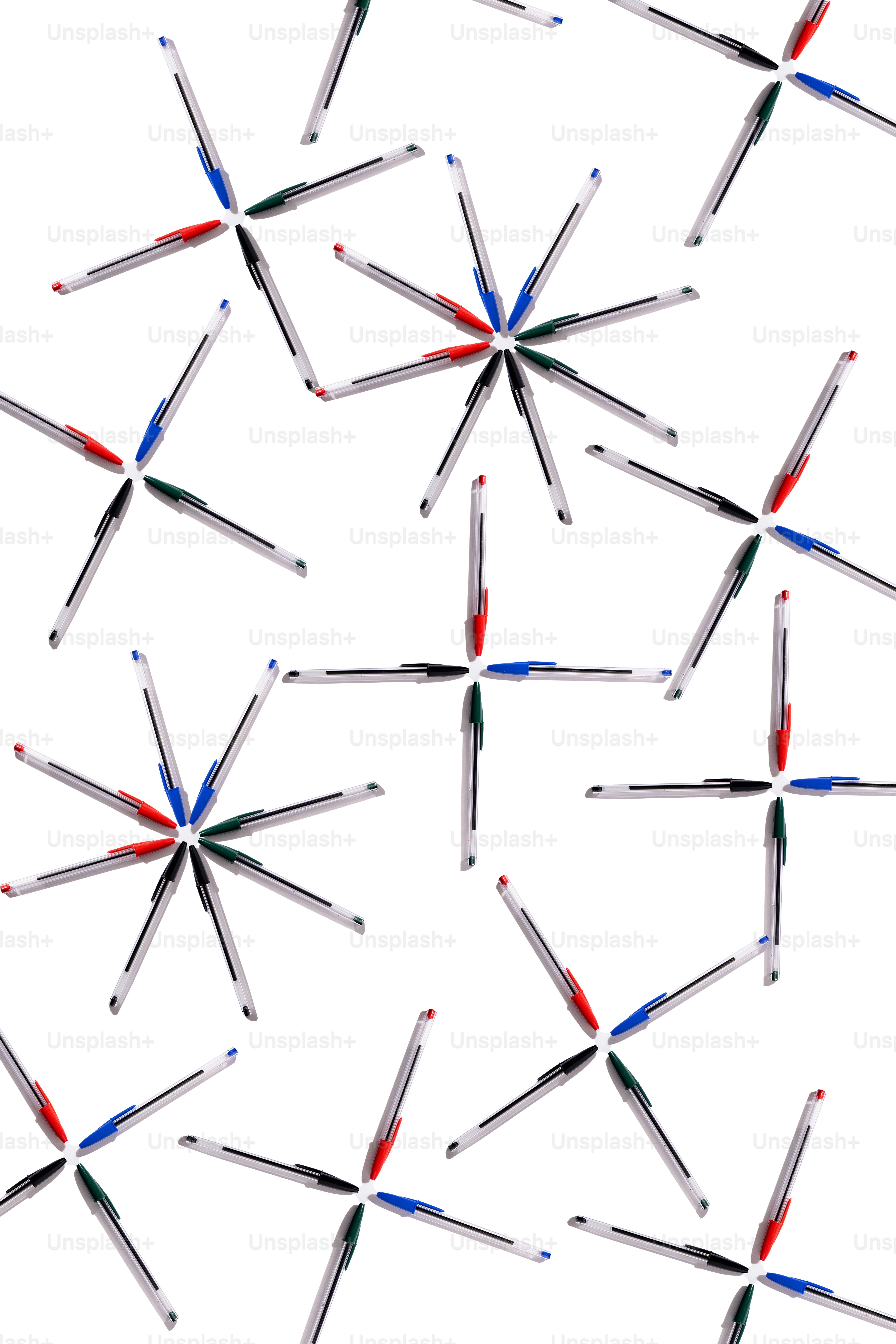 Pens arranged in starburst patterns on white background