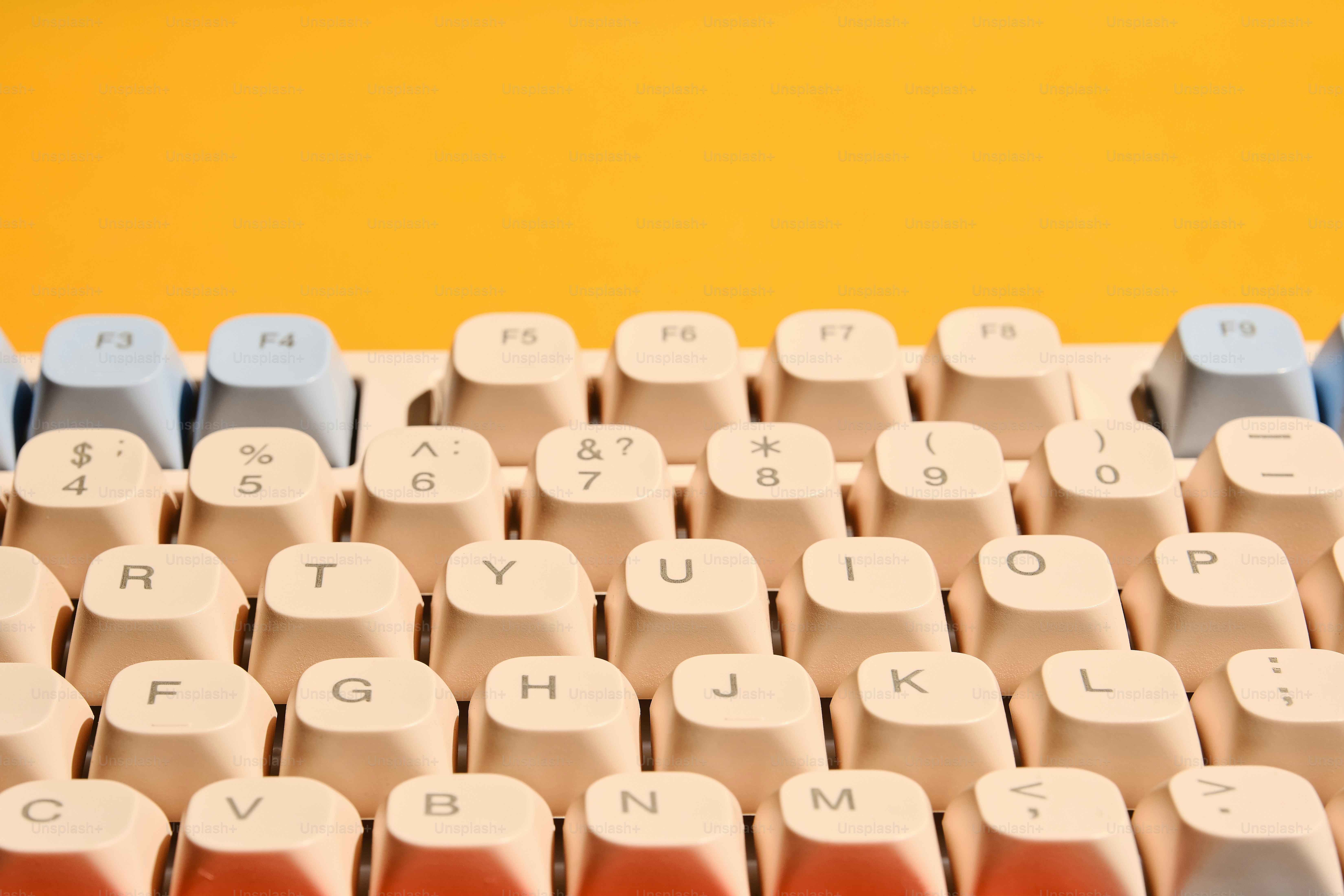 Close-up of a vintage keyboard on yellow background