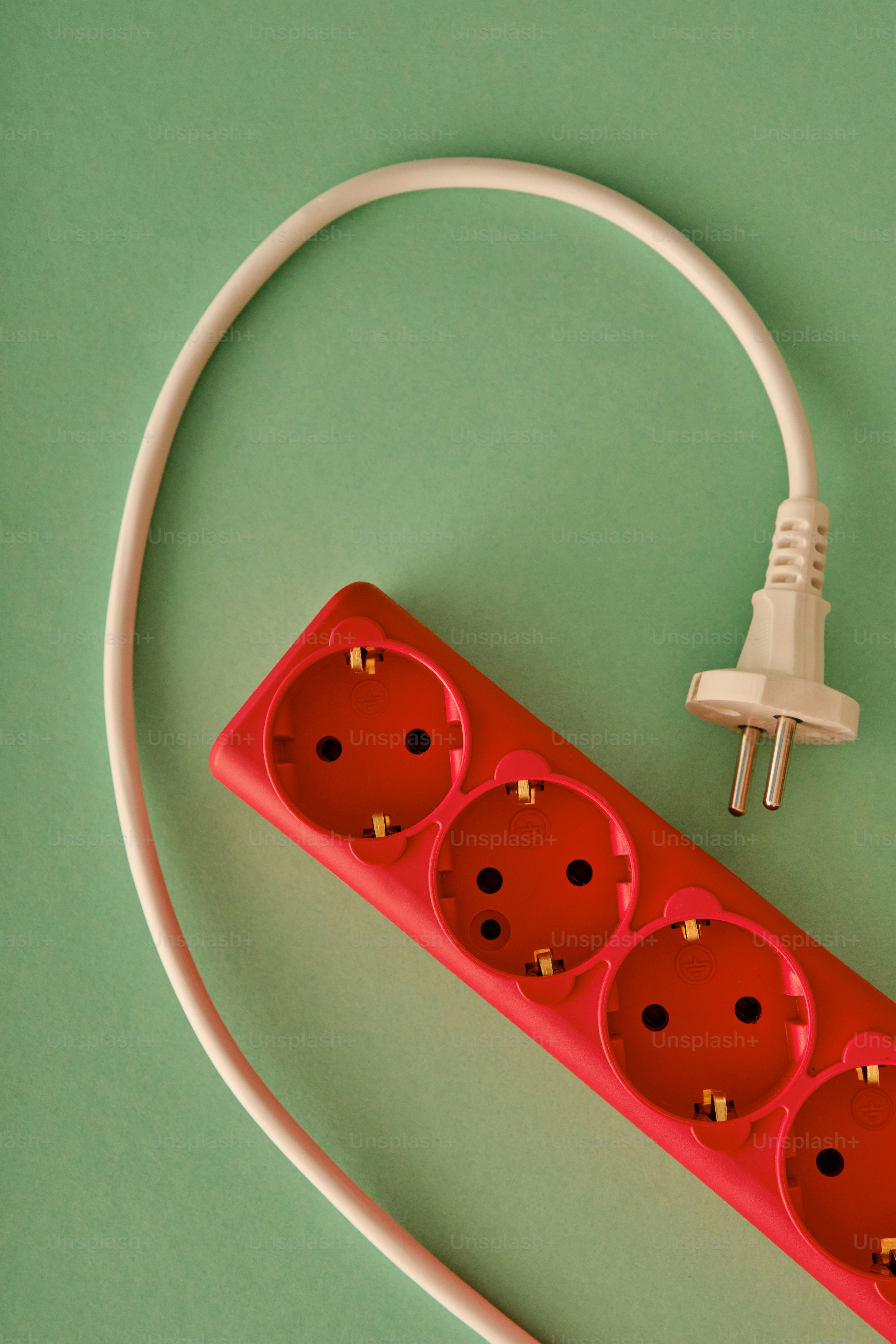 Red power strip with white cord and plug