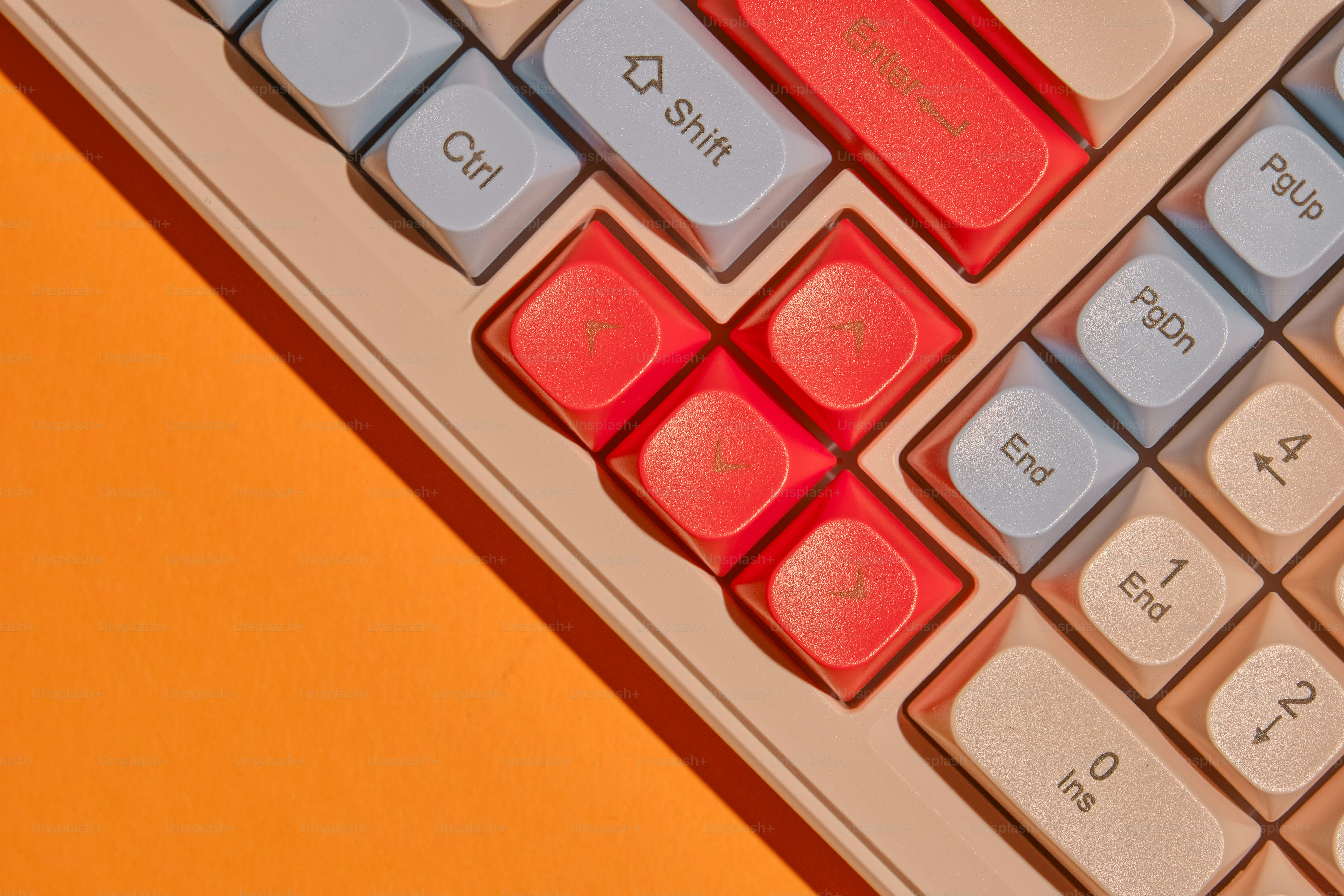 Close-up of a keyboard with red arrow keys.