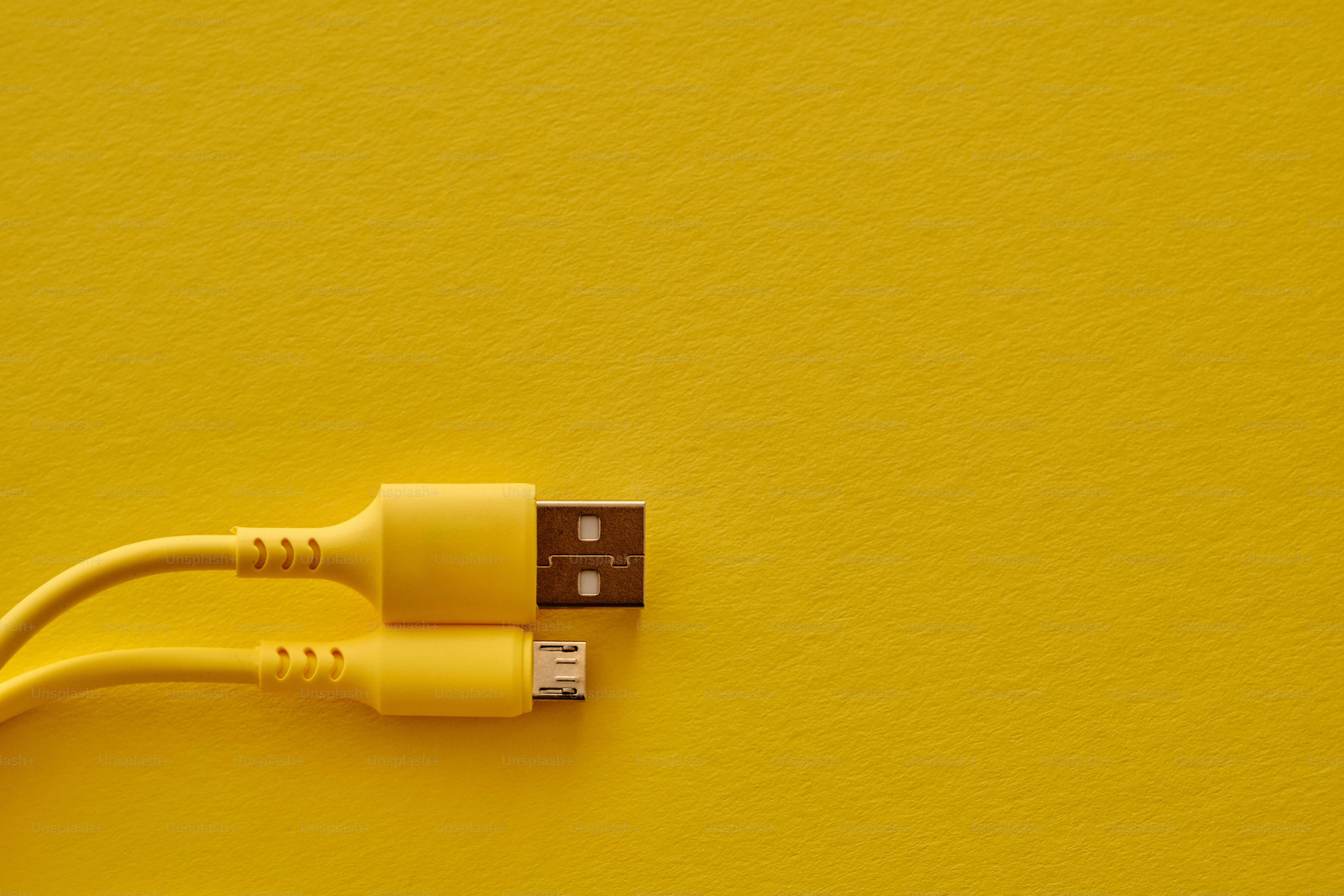 Two yellow usb cables on a yellow background photo – Technology Image ...