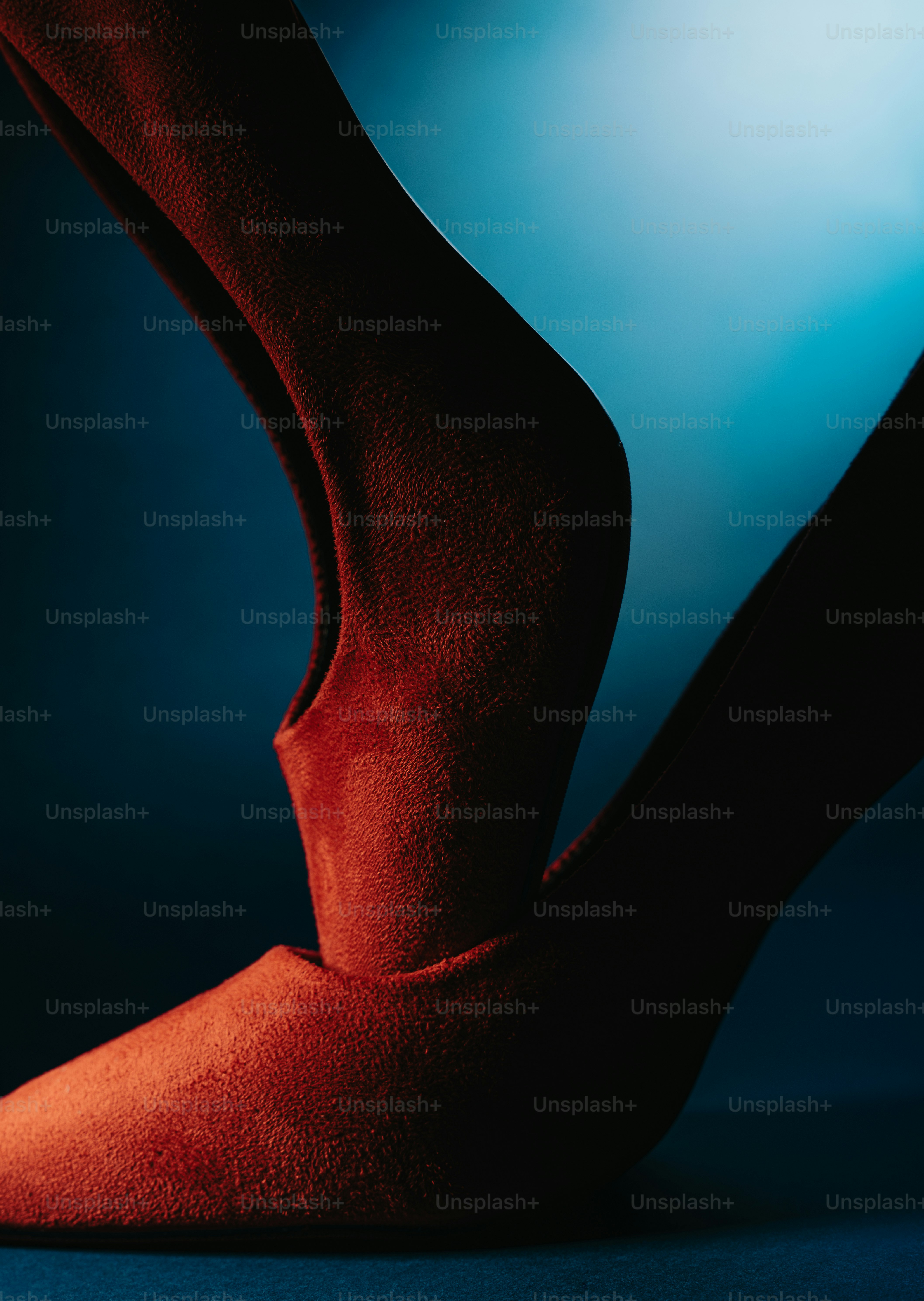 Red fabric draped in abstract form against blue background