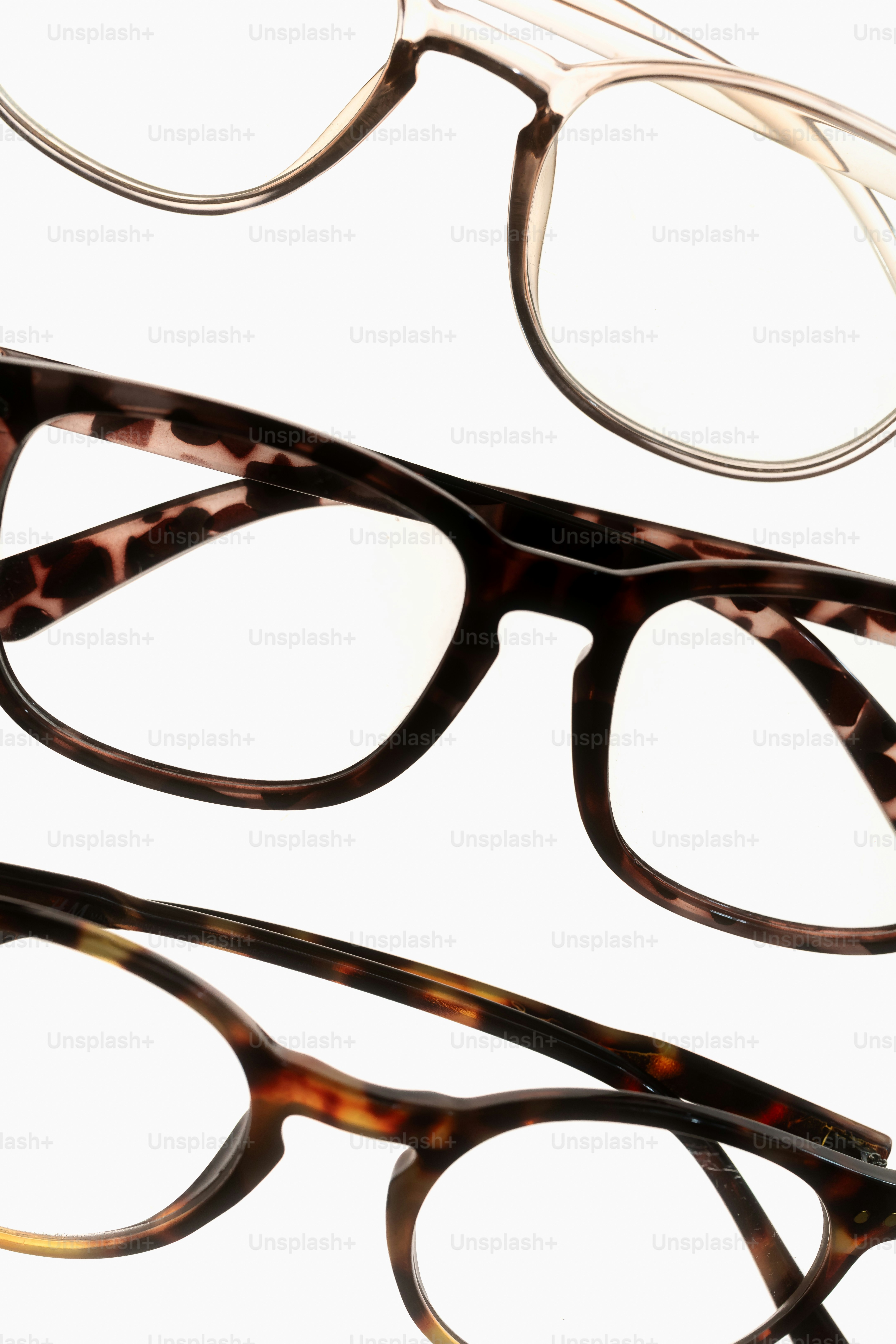 Three pairs of eyeglasses on a white background
