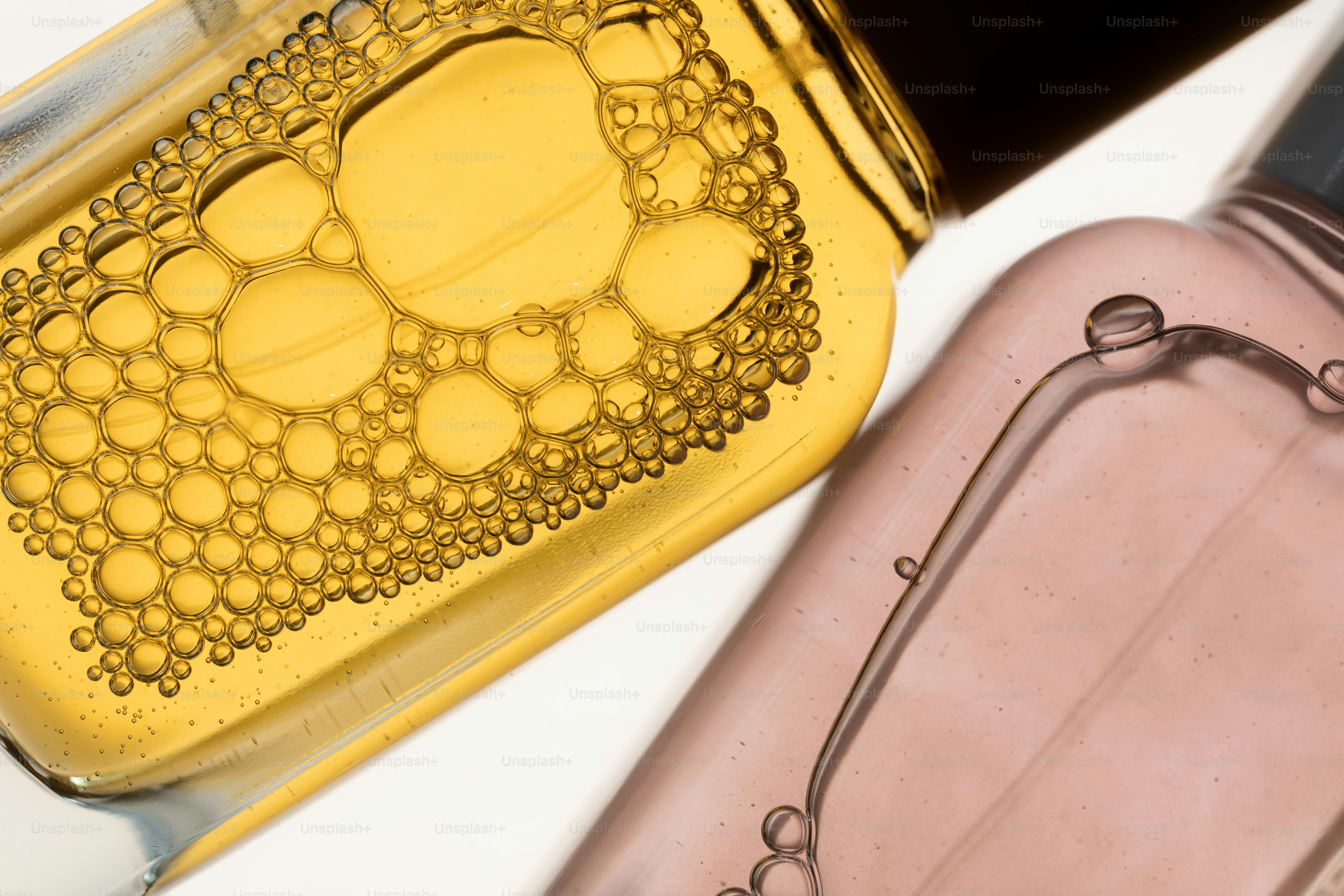 Two bottles with colorful liquids and bubbles