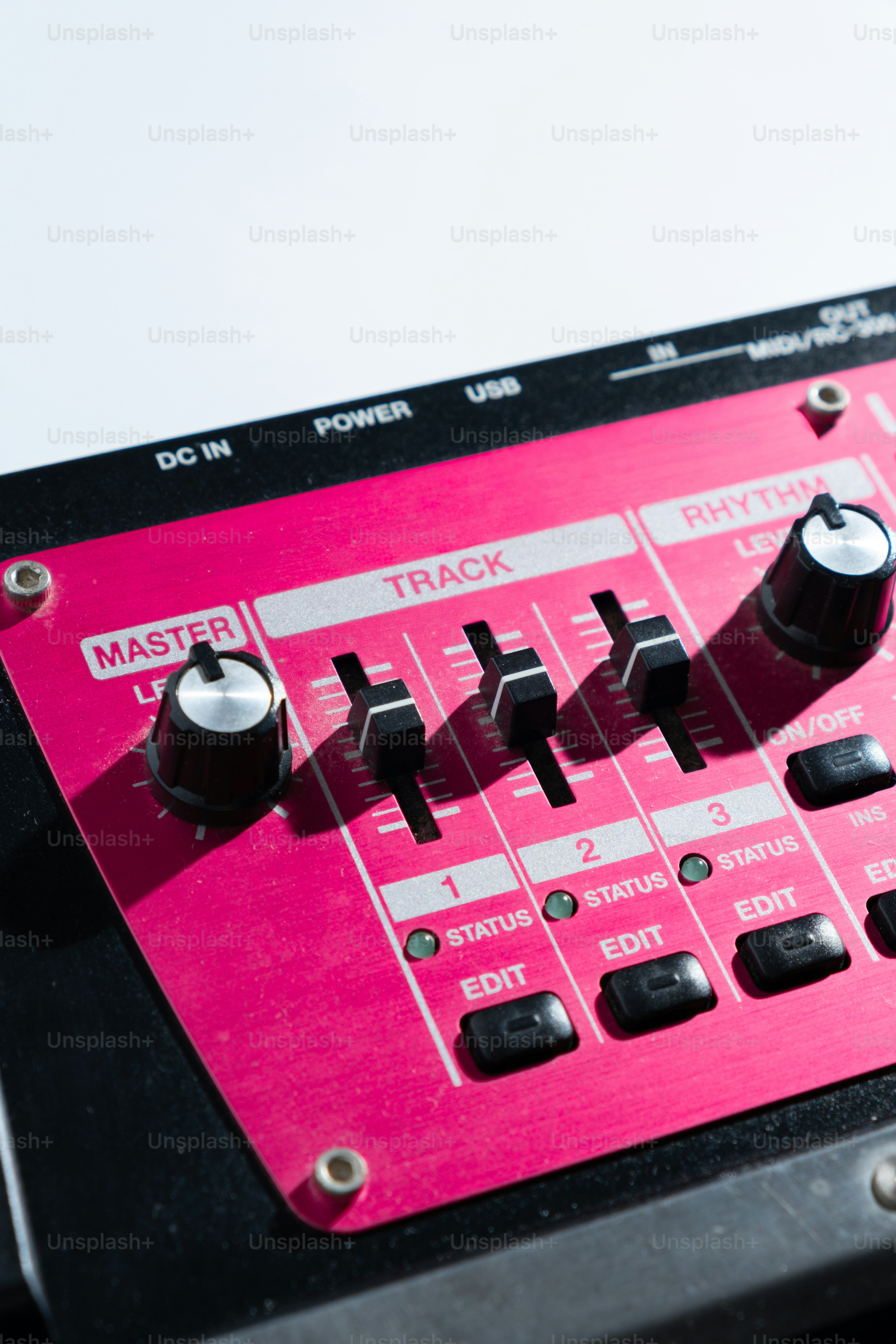 Close-up of a digital audio mixer with sliders