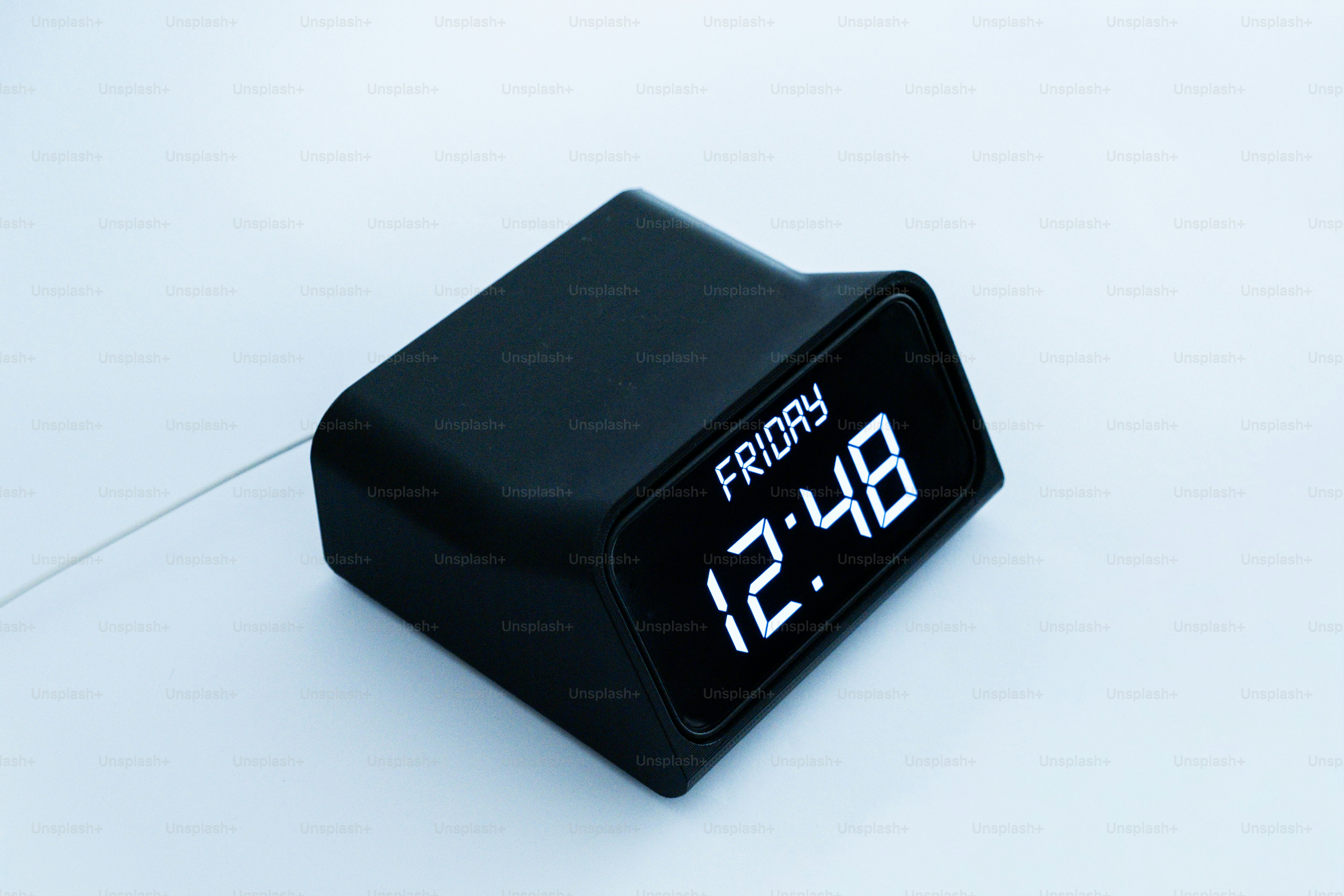 Black digital clock displays friday 12:48