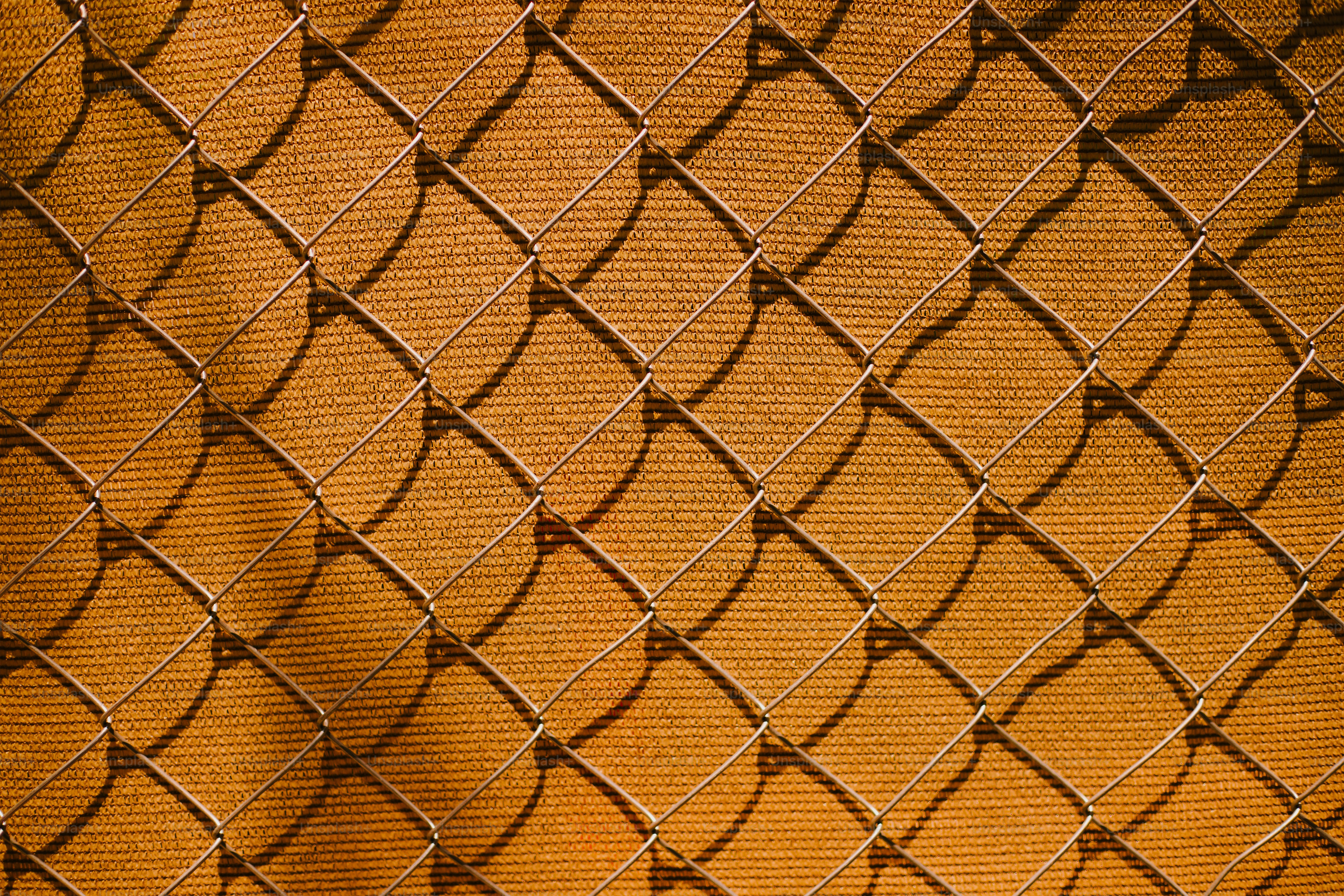 Close-up of a chain-link fence casting shadows photo – Abstract background  Image on Unsplash