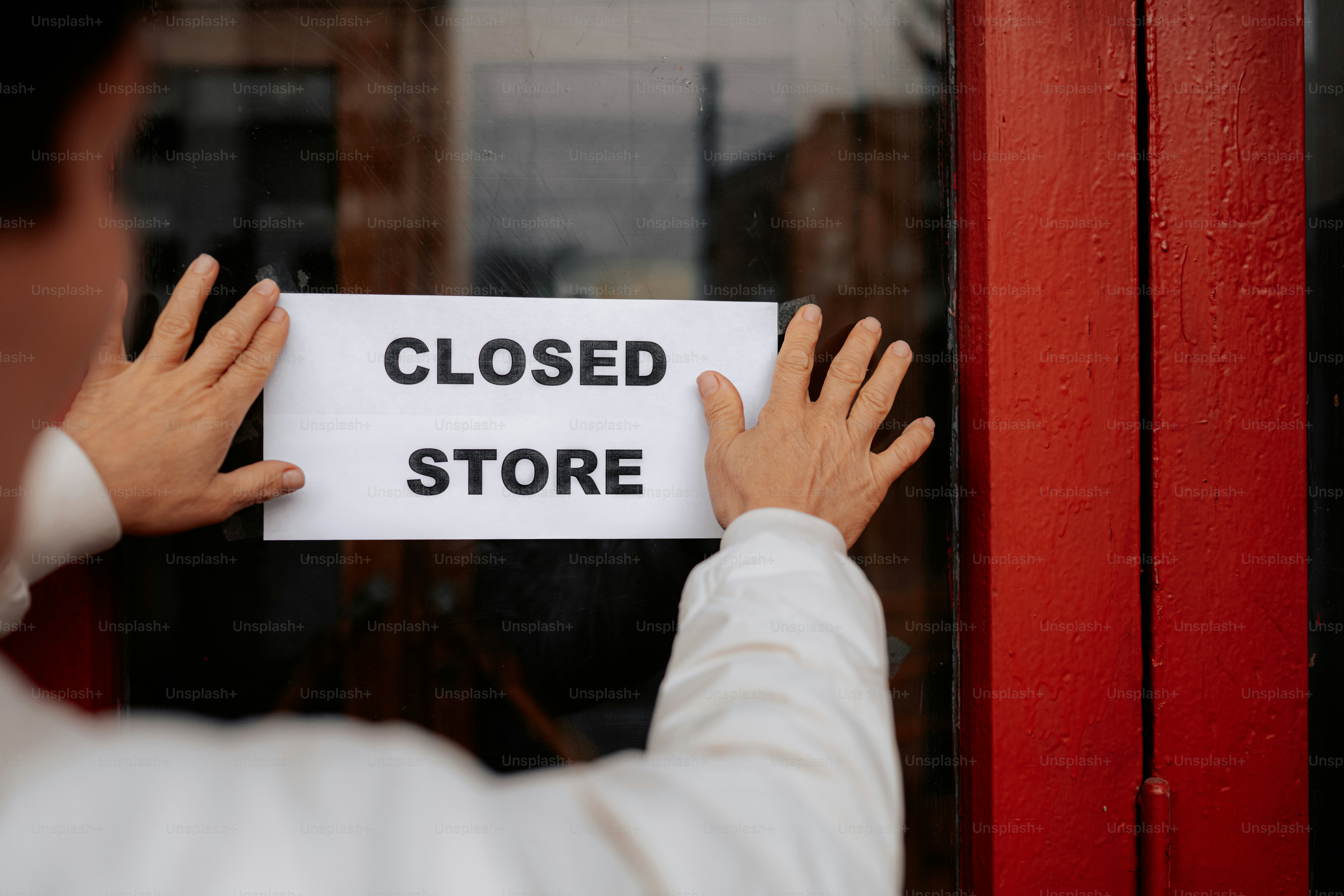 Person hangs sign on store door