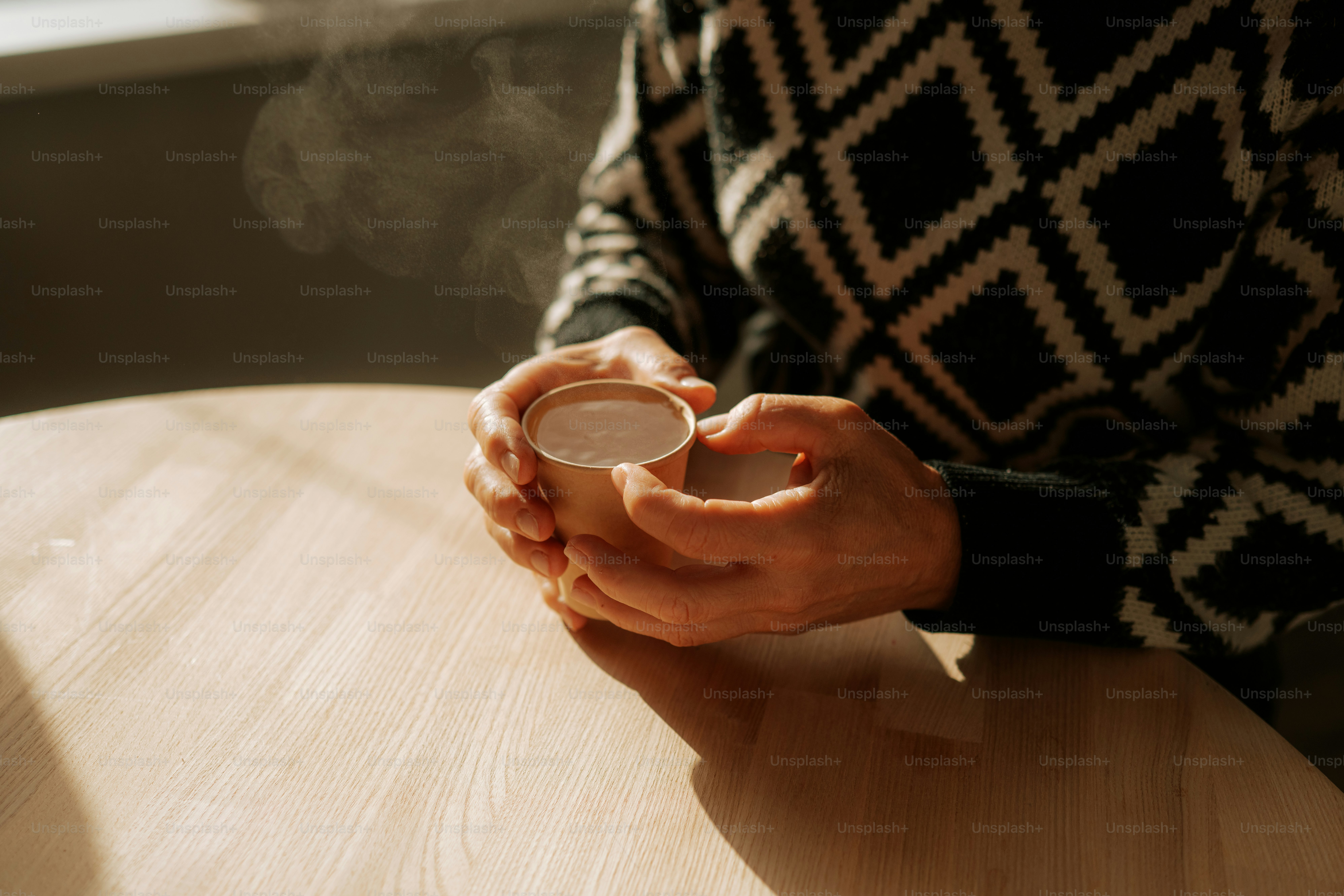Hands holding a warm cup of coffee