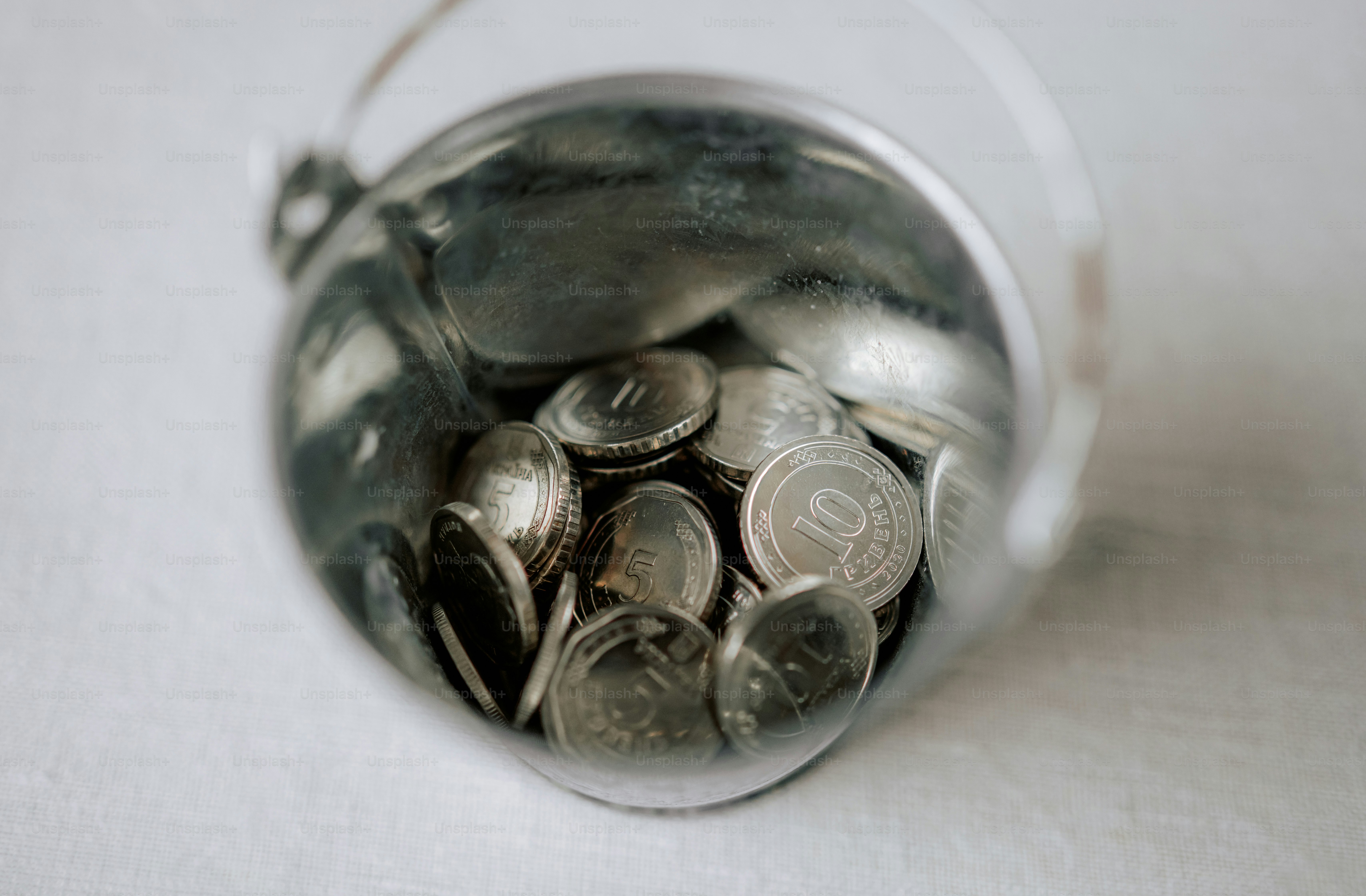 Glass jar filled with silver coins