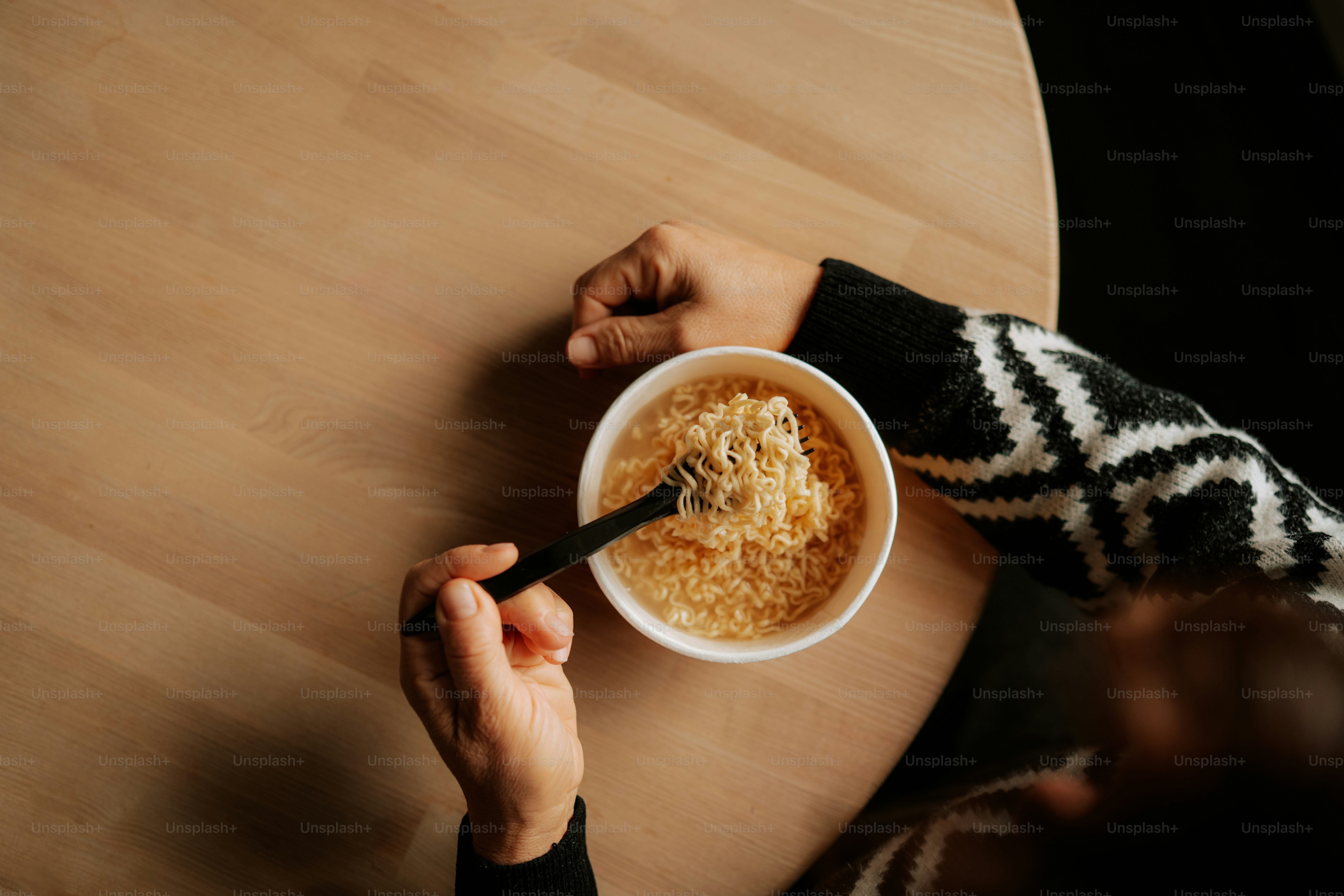 Person eating cereal from a bowl with a spoon