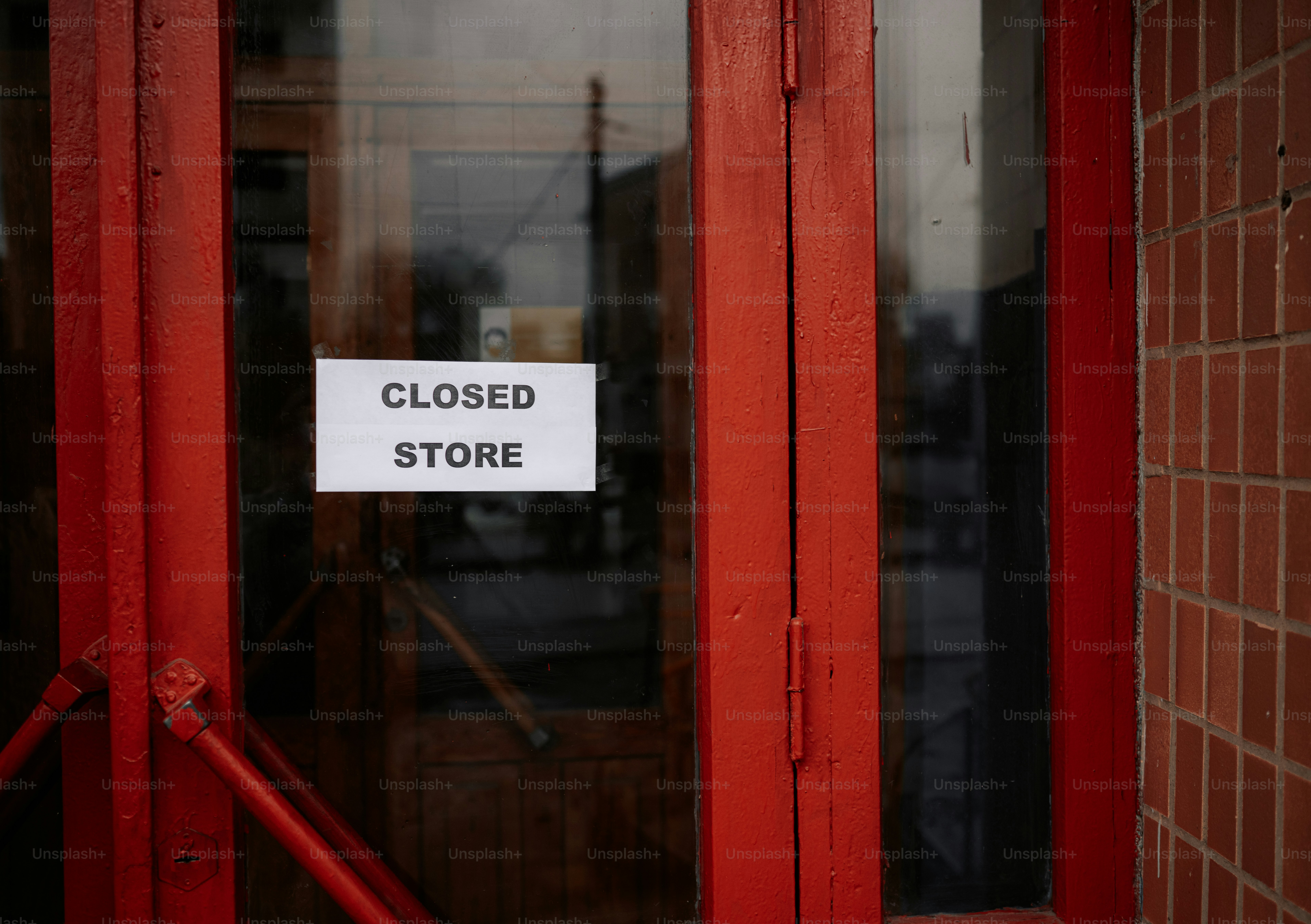 Red doors with a closed store sign