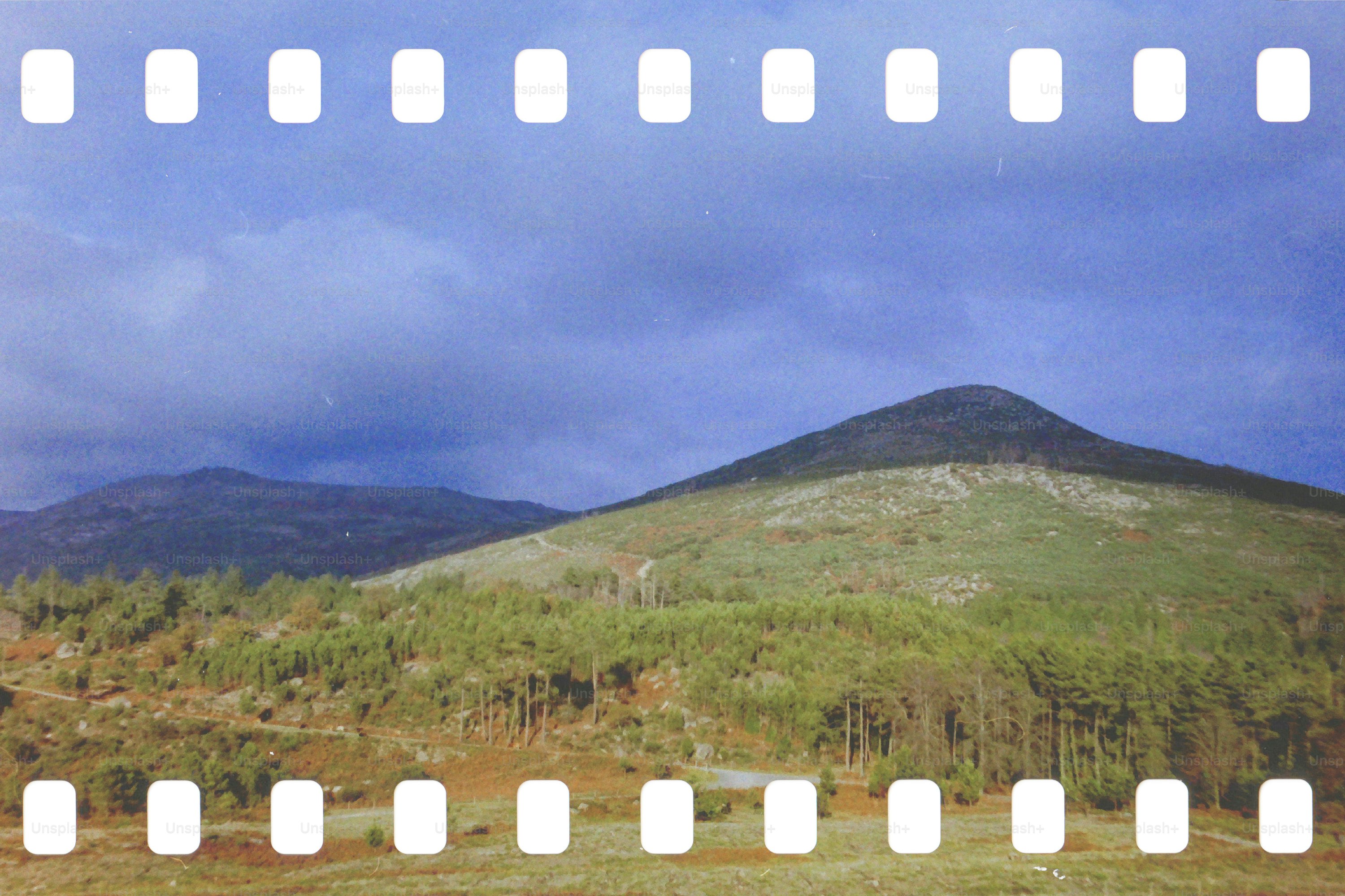Green mountain landscape under cloudy sky