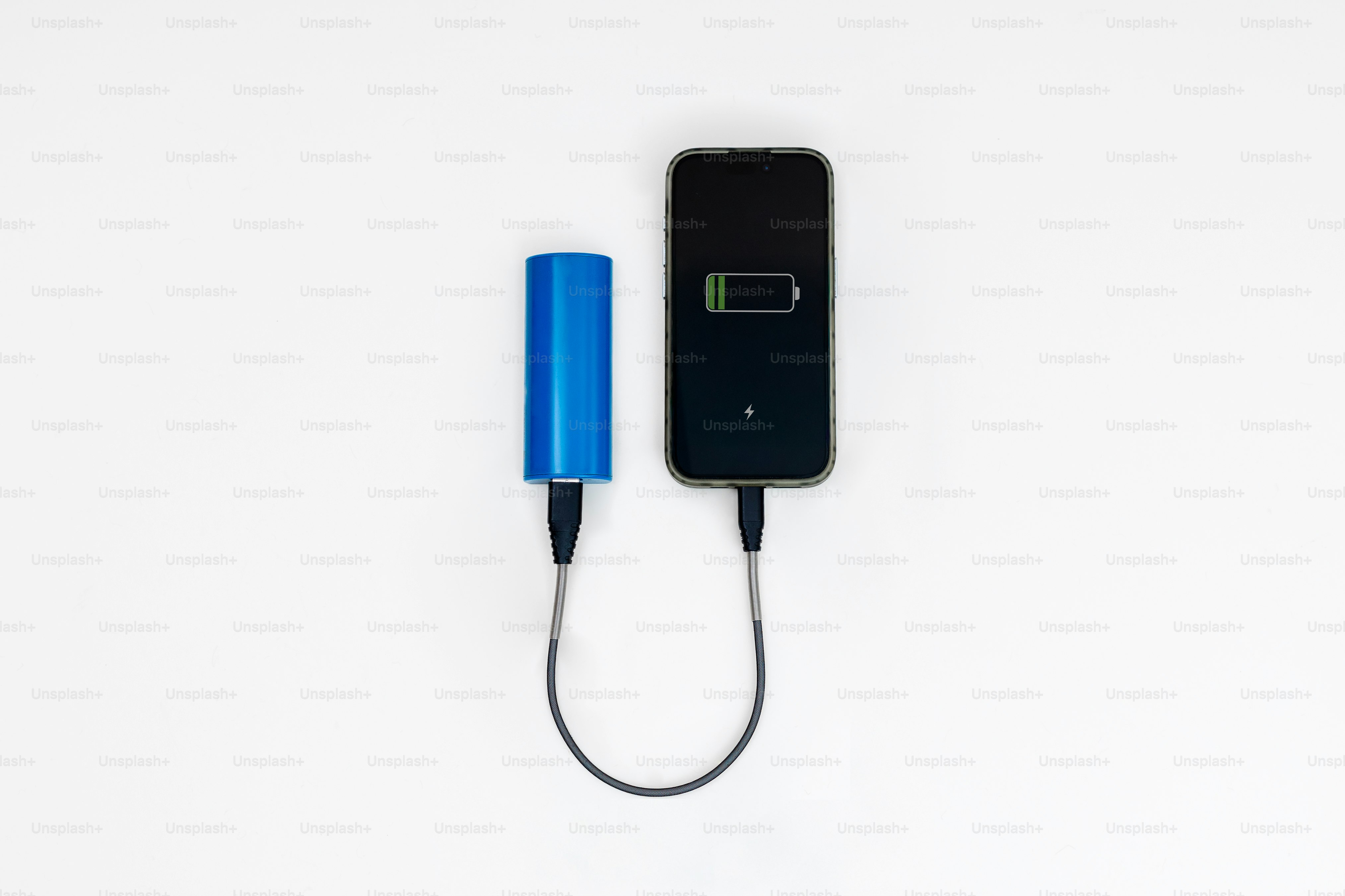 A blue power bank charges a smartphone on white background