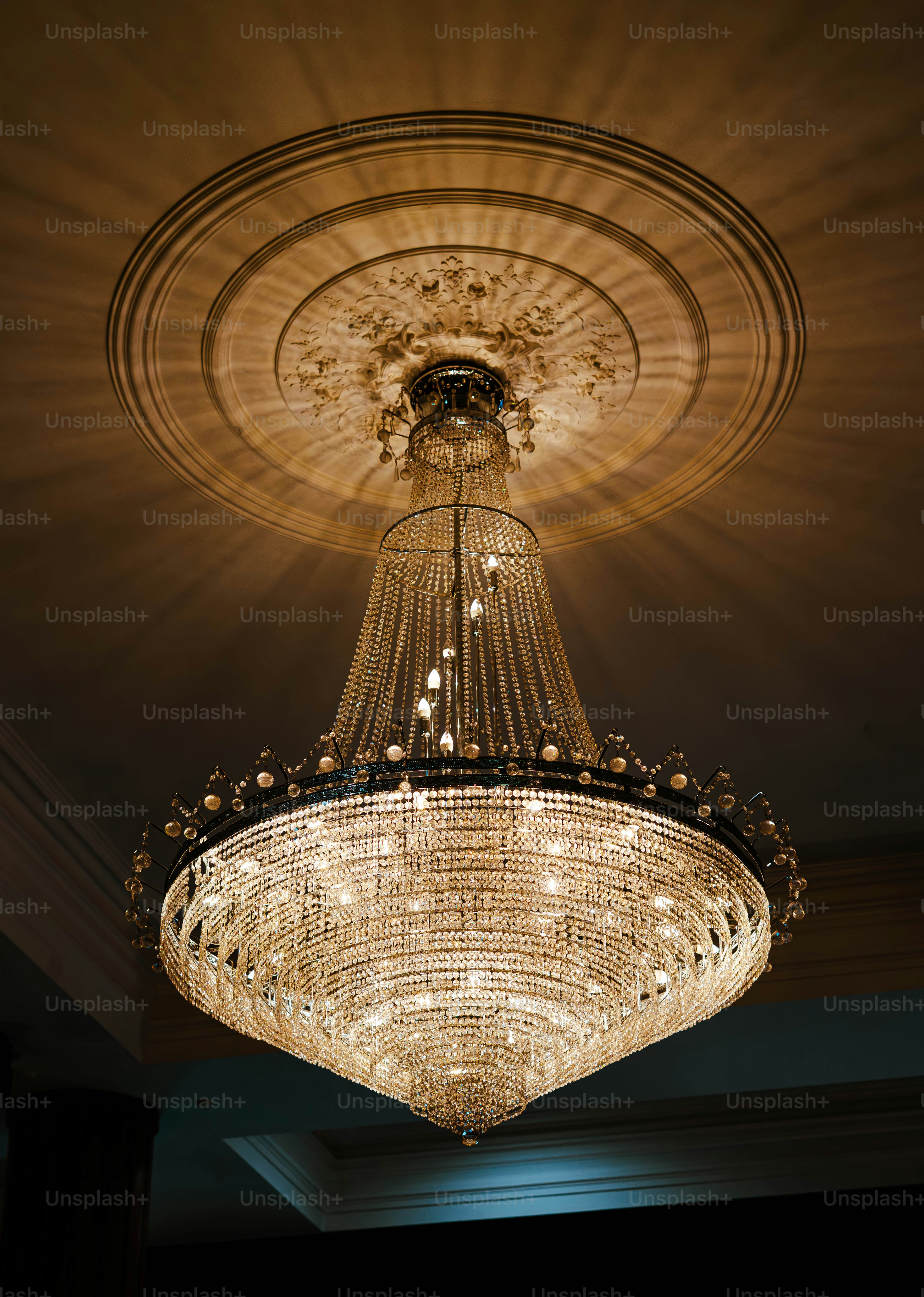 A grand crystal chandelier illuminated from within.