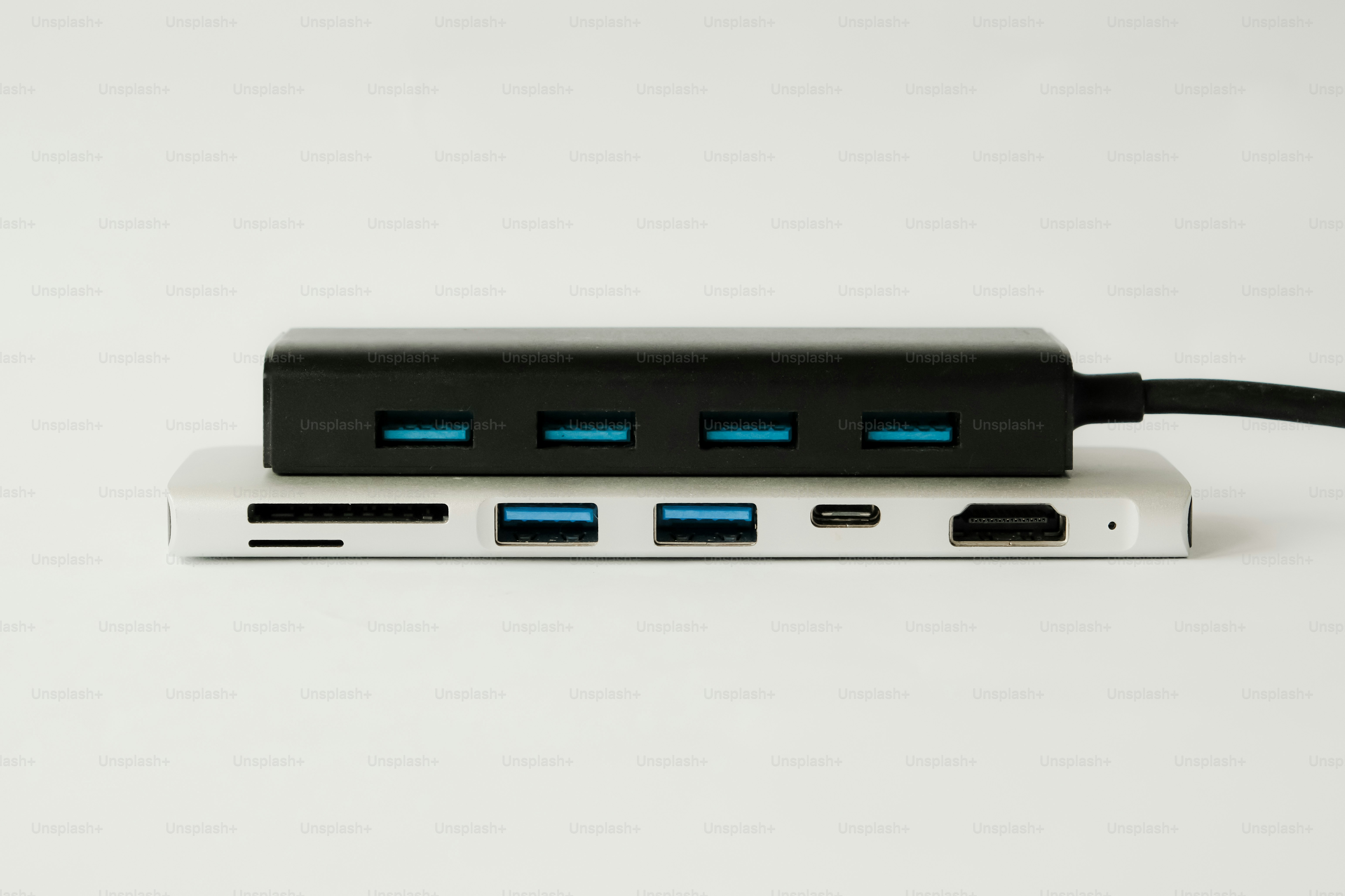 Two usb hubs stacked on a white surface.