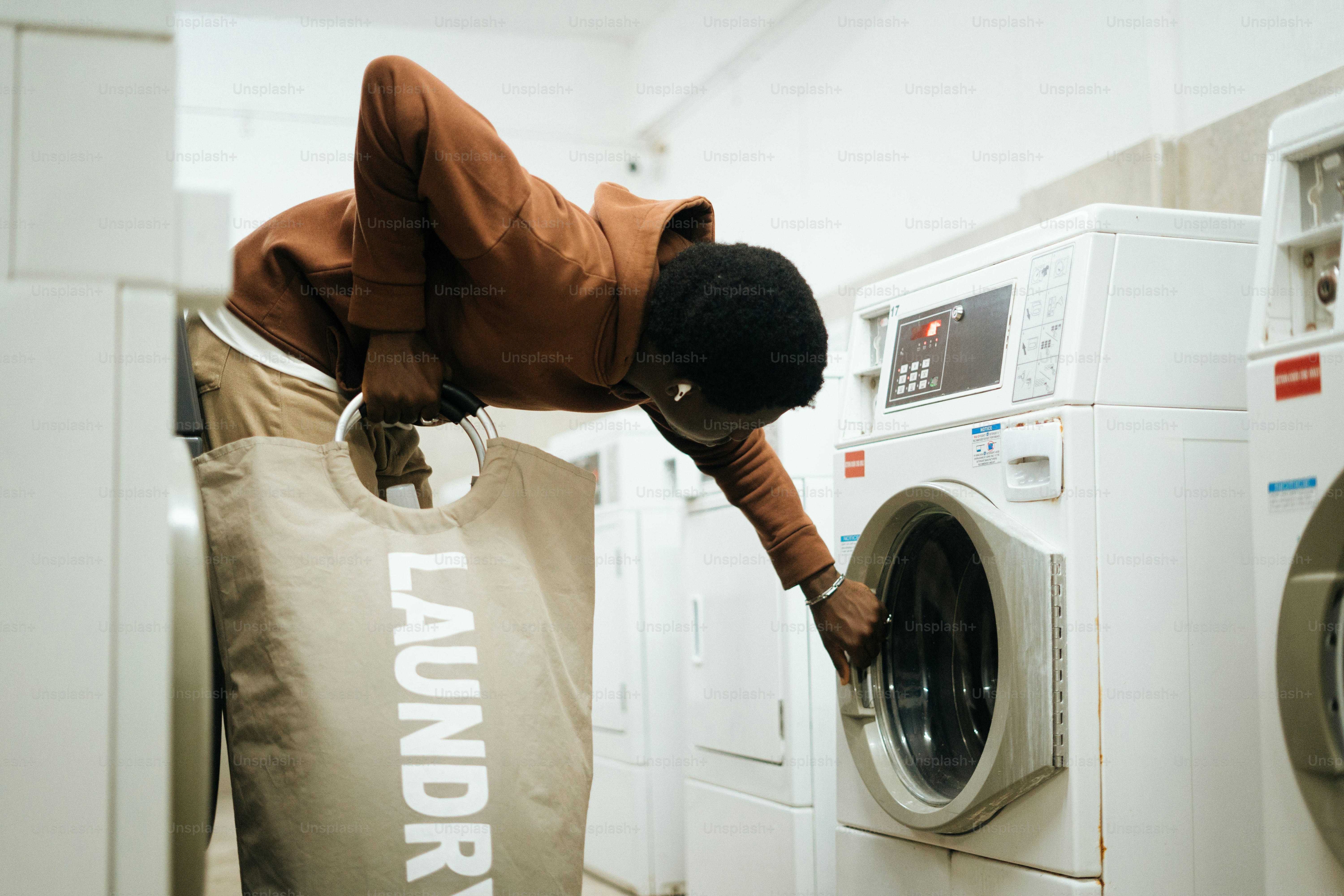 Man loading laundry into washing machine
