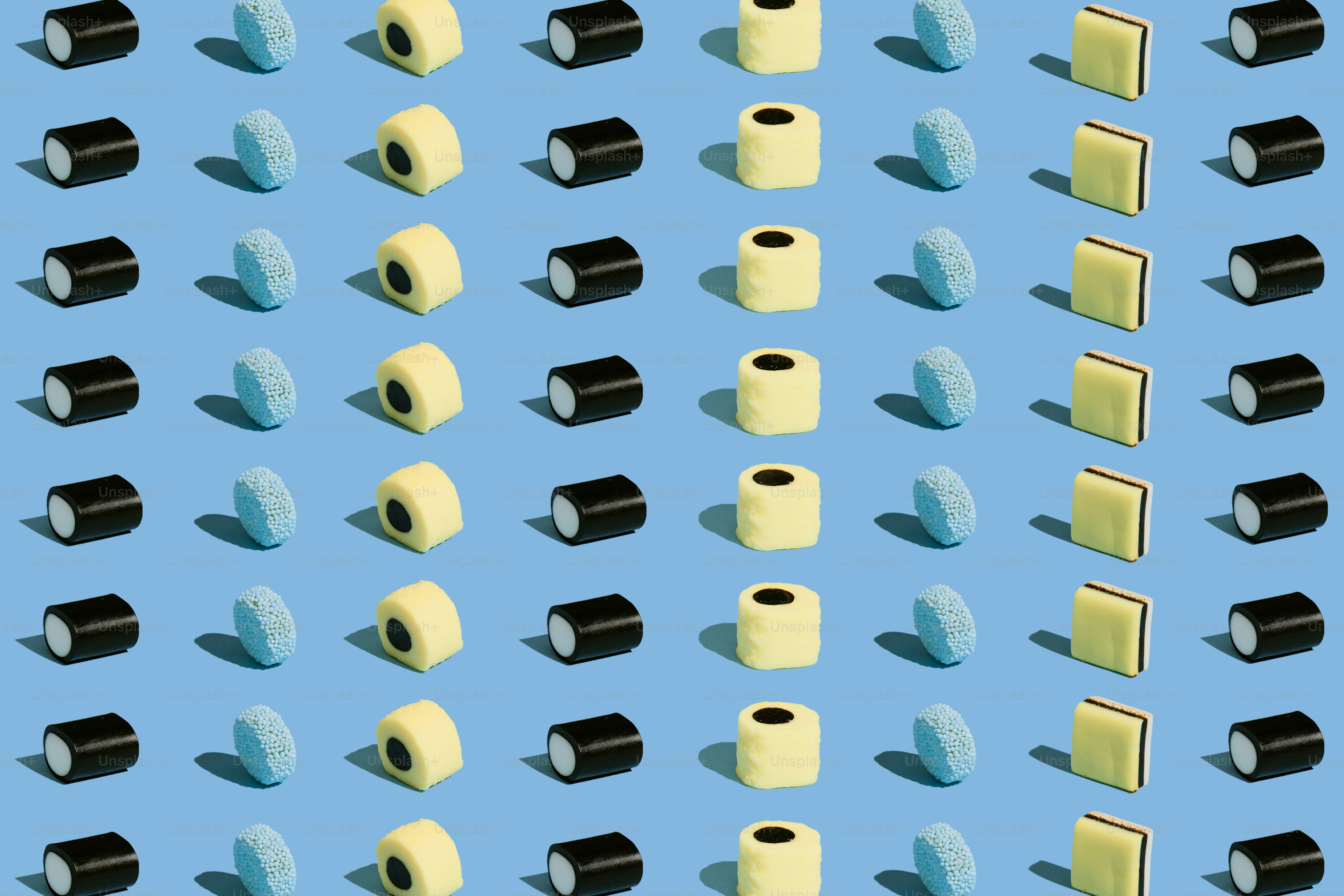 Pattern of black, yellow, and blue objects on blue background