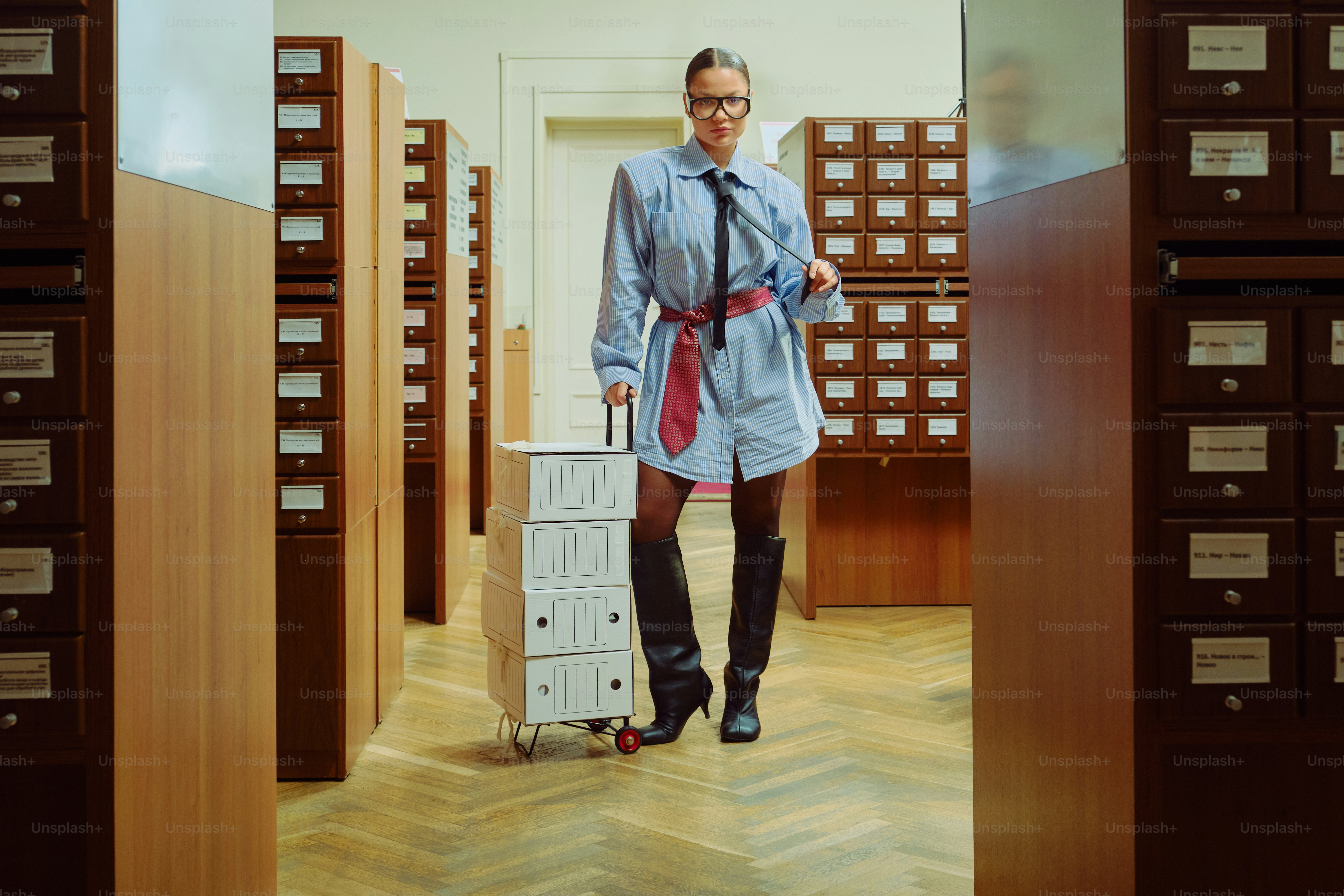 Woman with luggage in a library archive