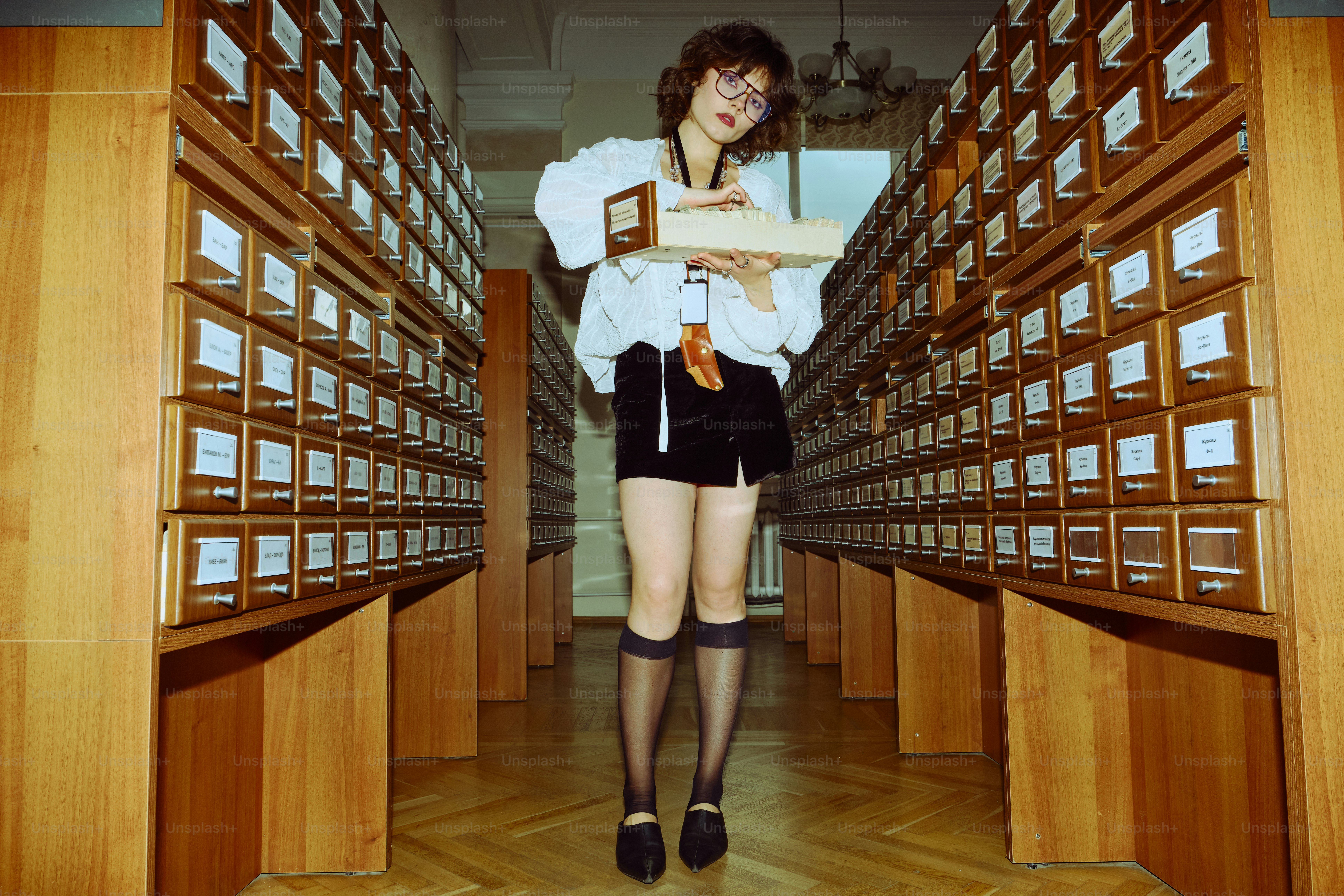 Woman holding box in library archive