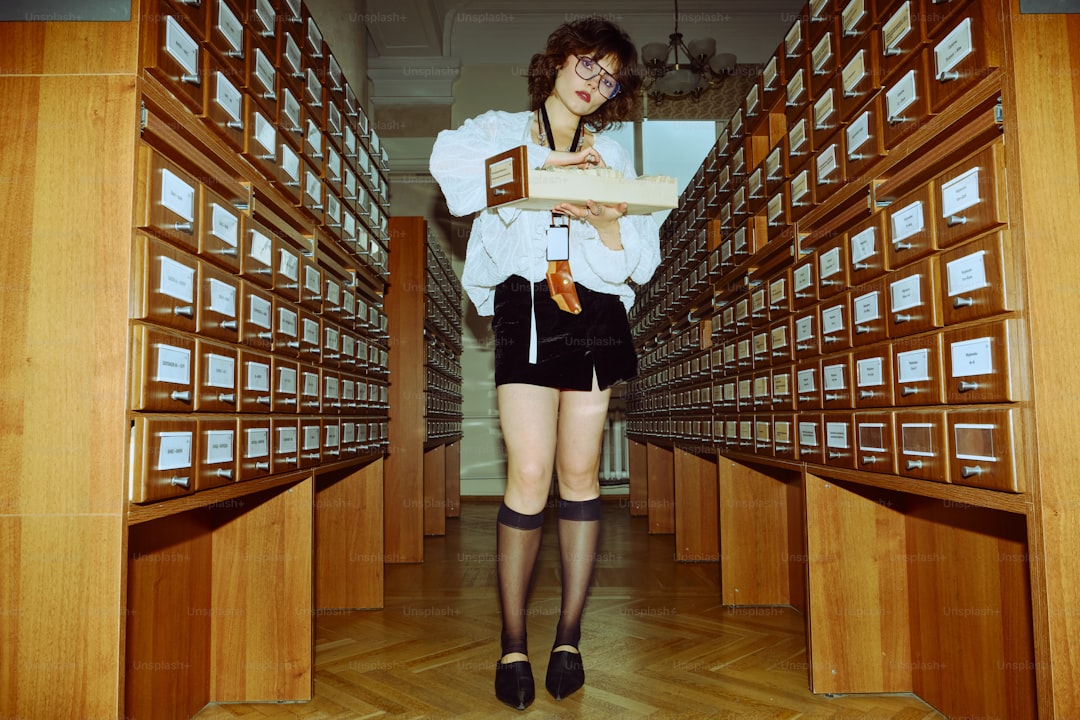 Woman holding box in library archive