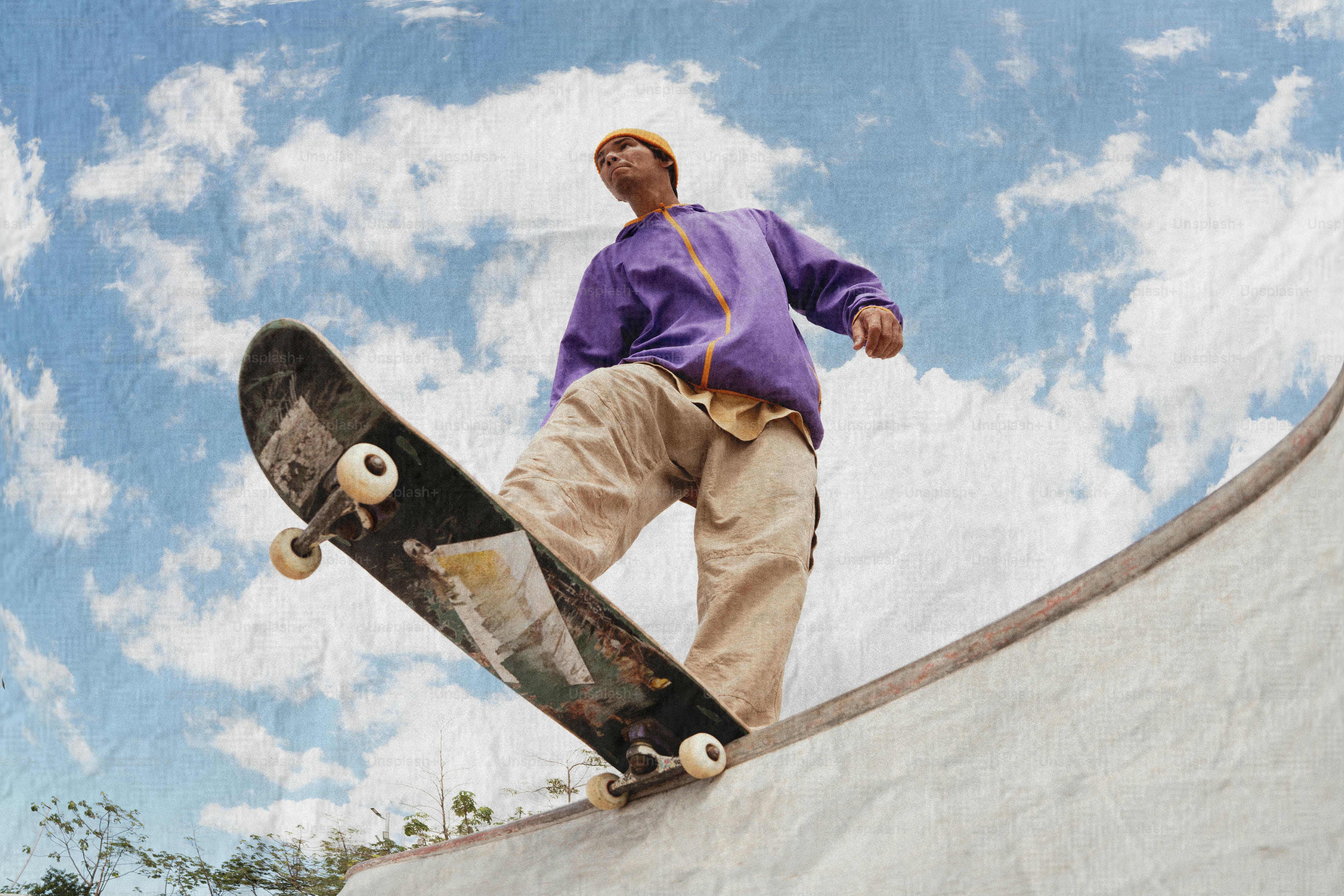 Skateboarder rides on the edge of a ramp
