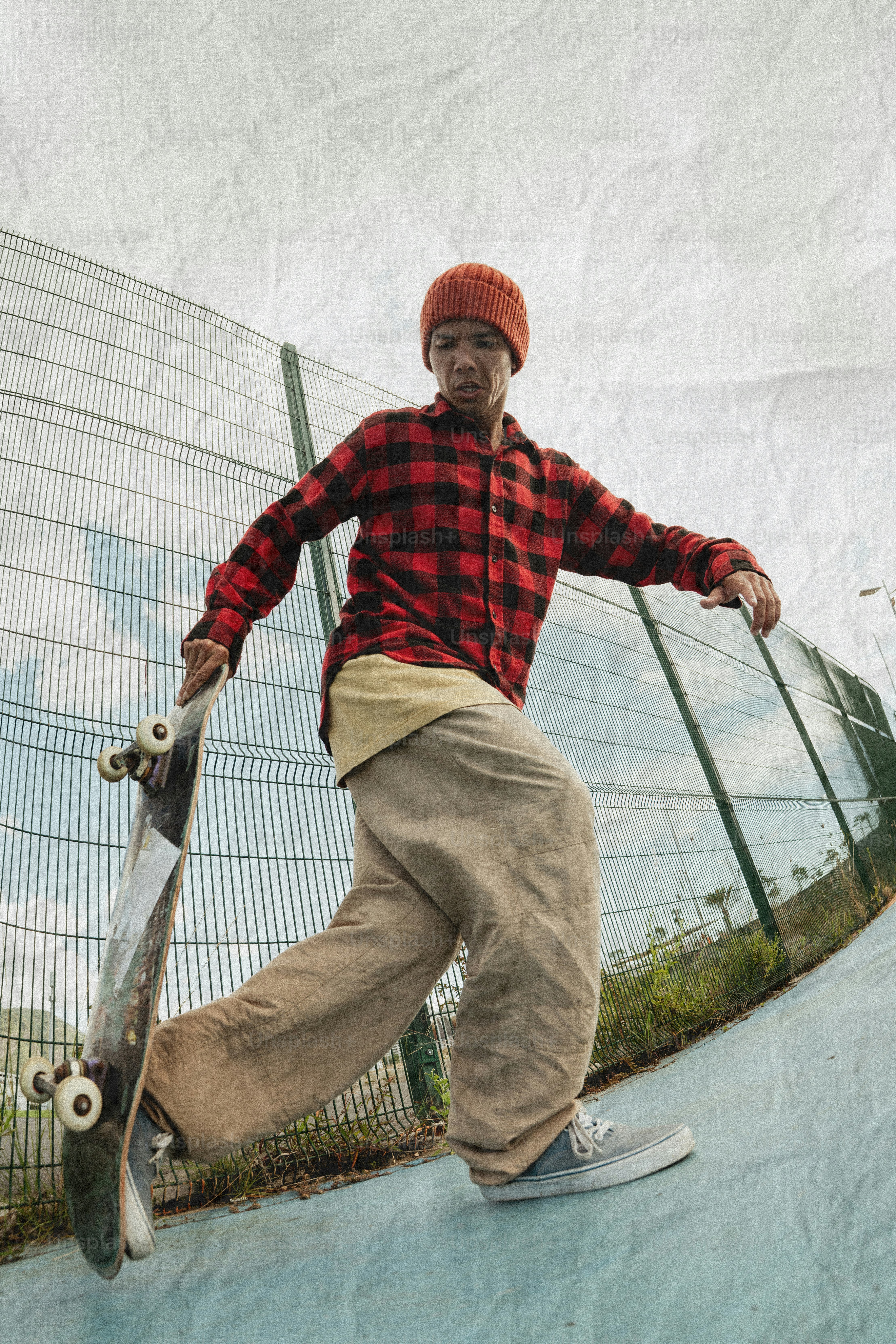 Young man with skateboard at skatepark