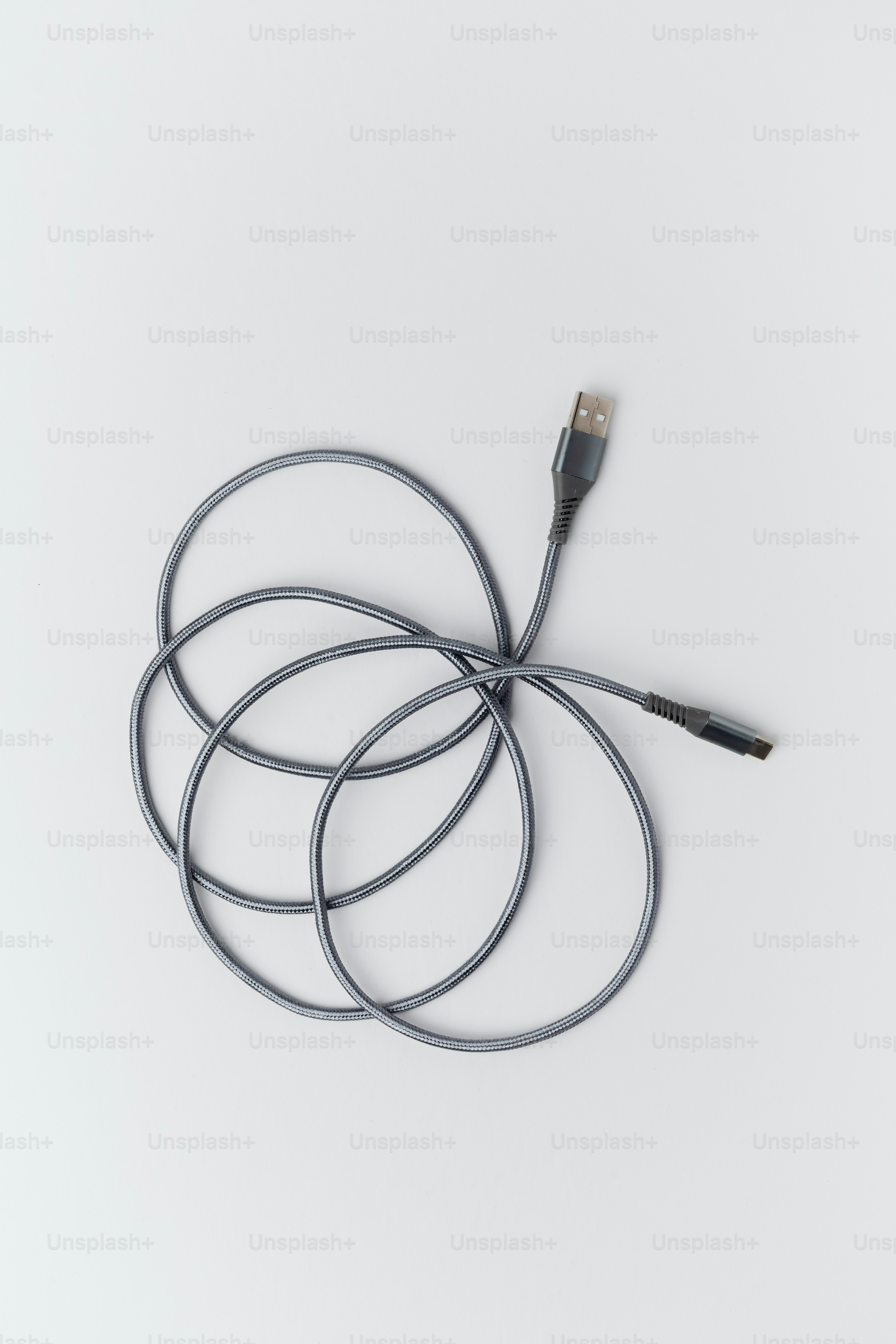 A coiled black and gray usb charging cable