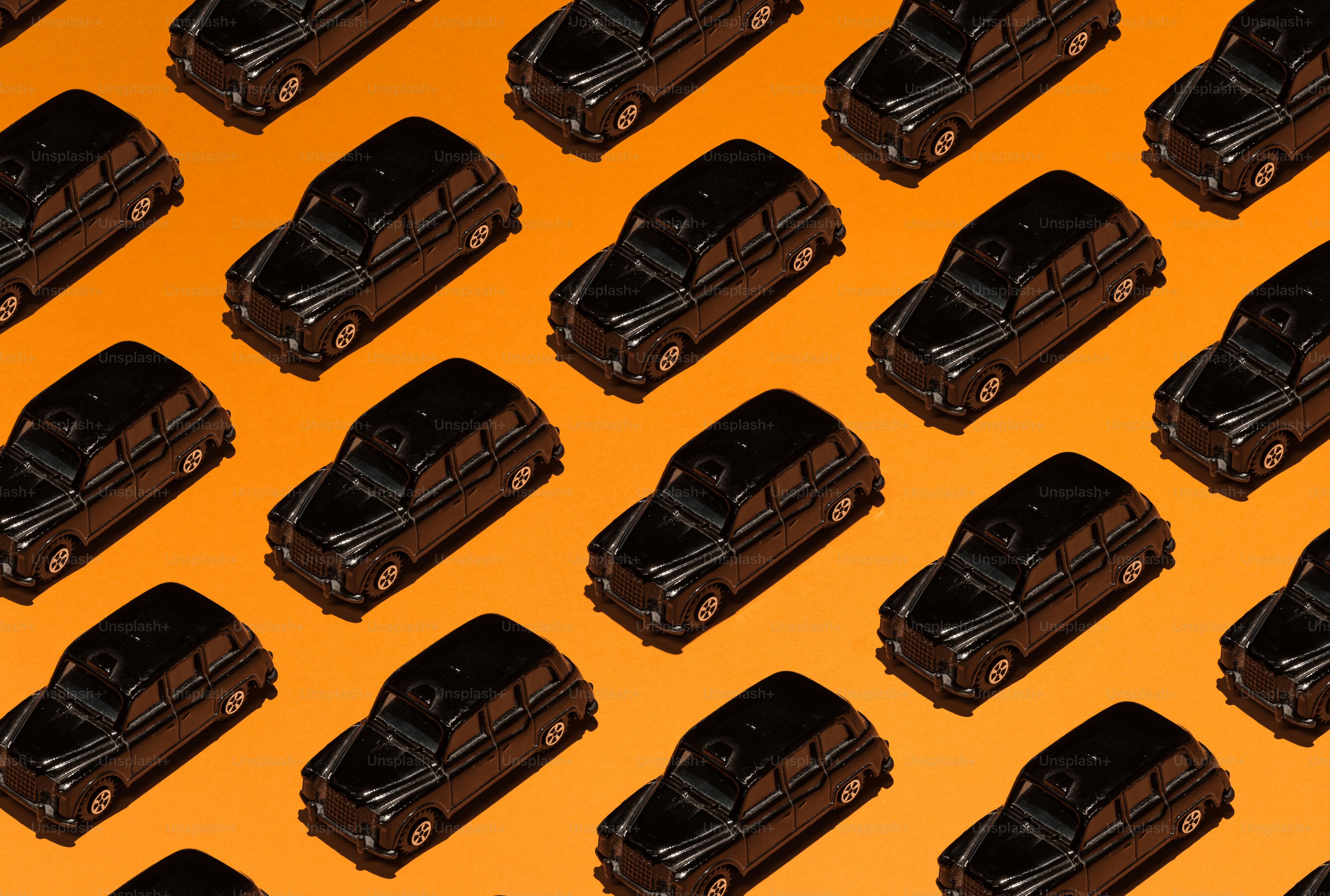 Pattern of black vintage cars on orange background