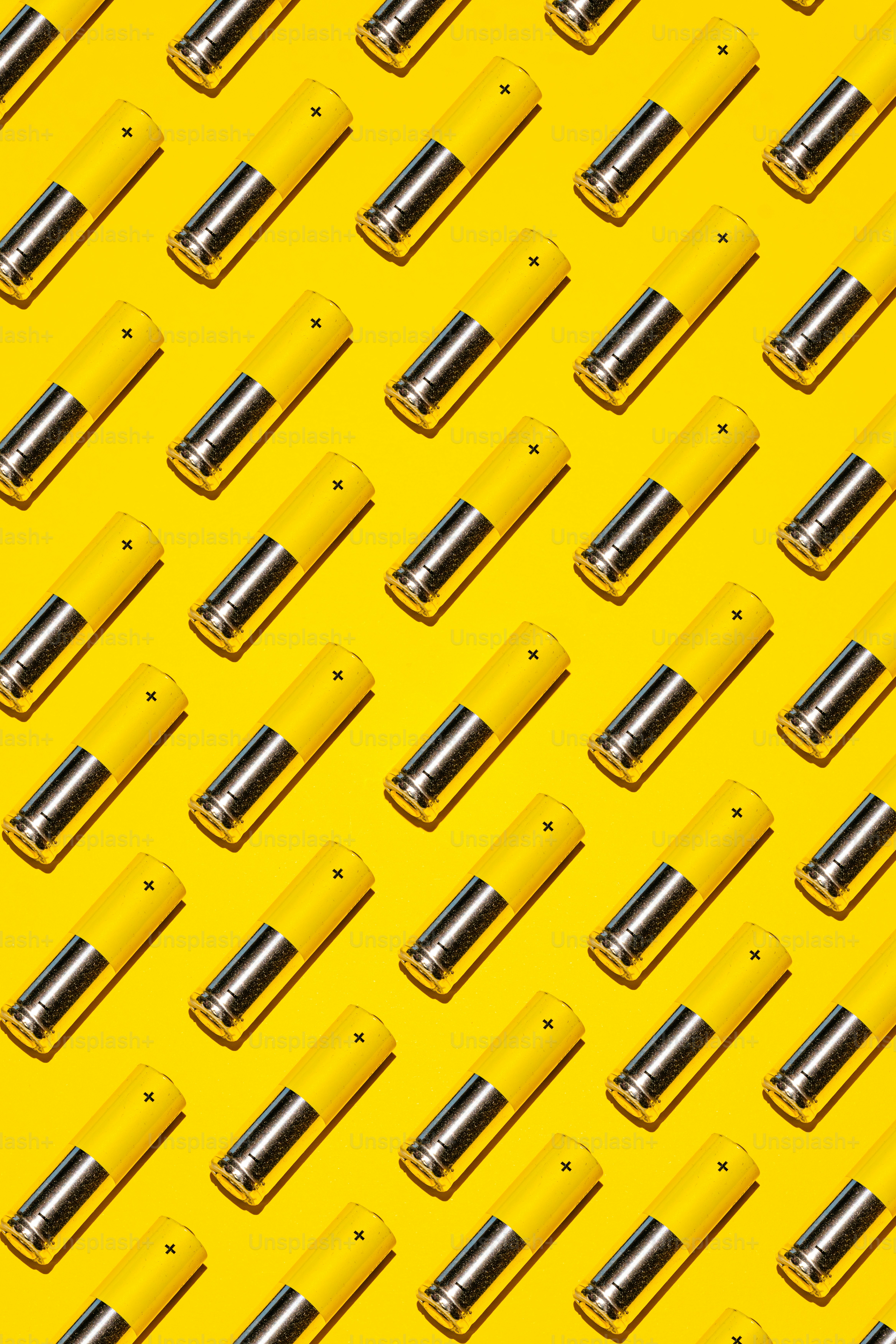 Yellow and silver objects arranged diagonally on yellow background