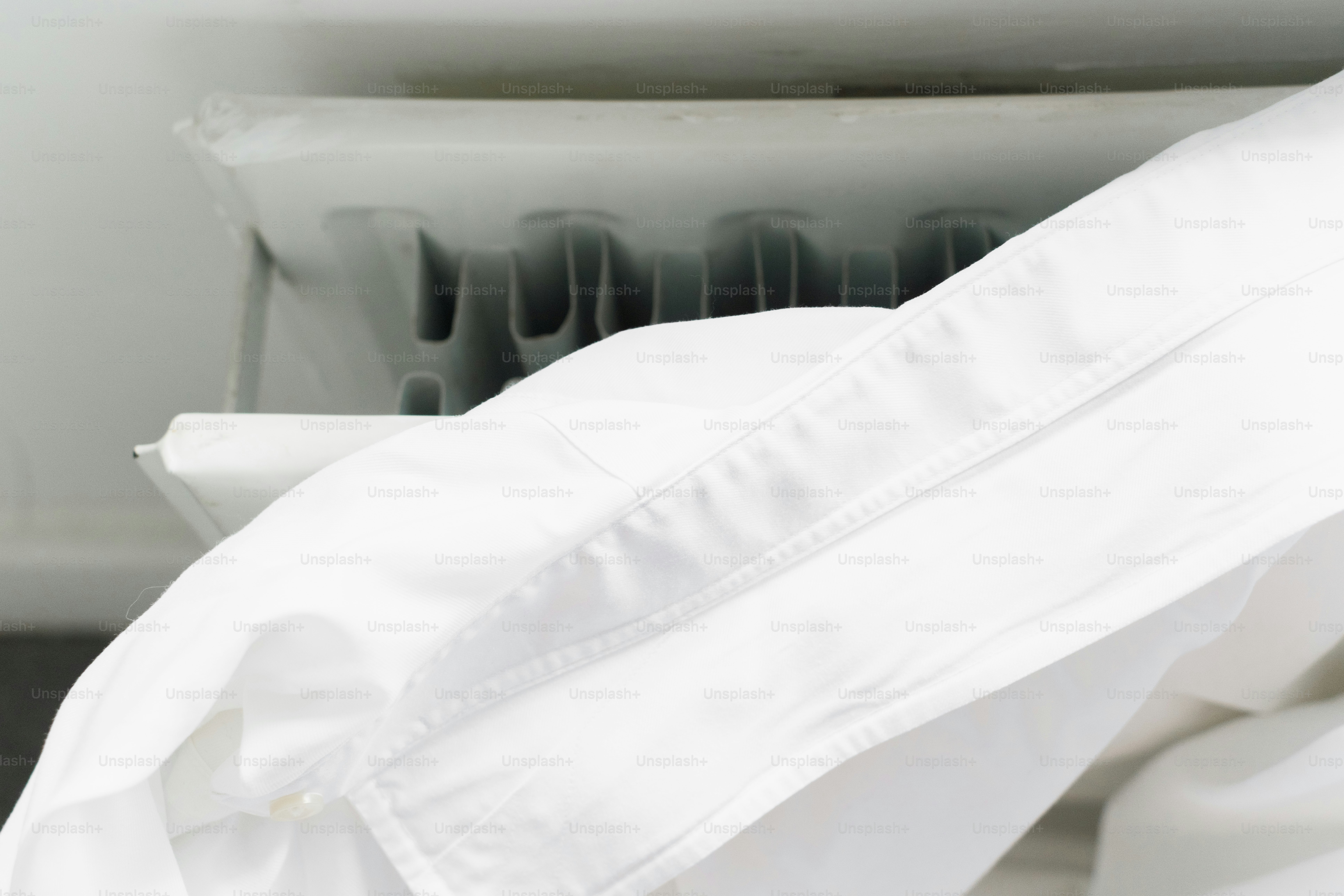 White duvet cover draped over a radiator