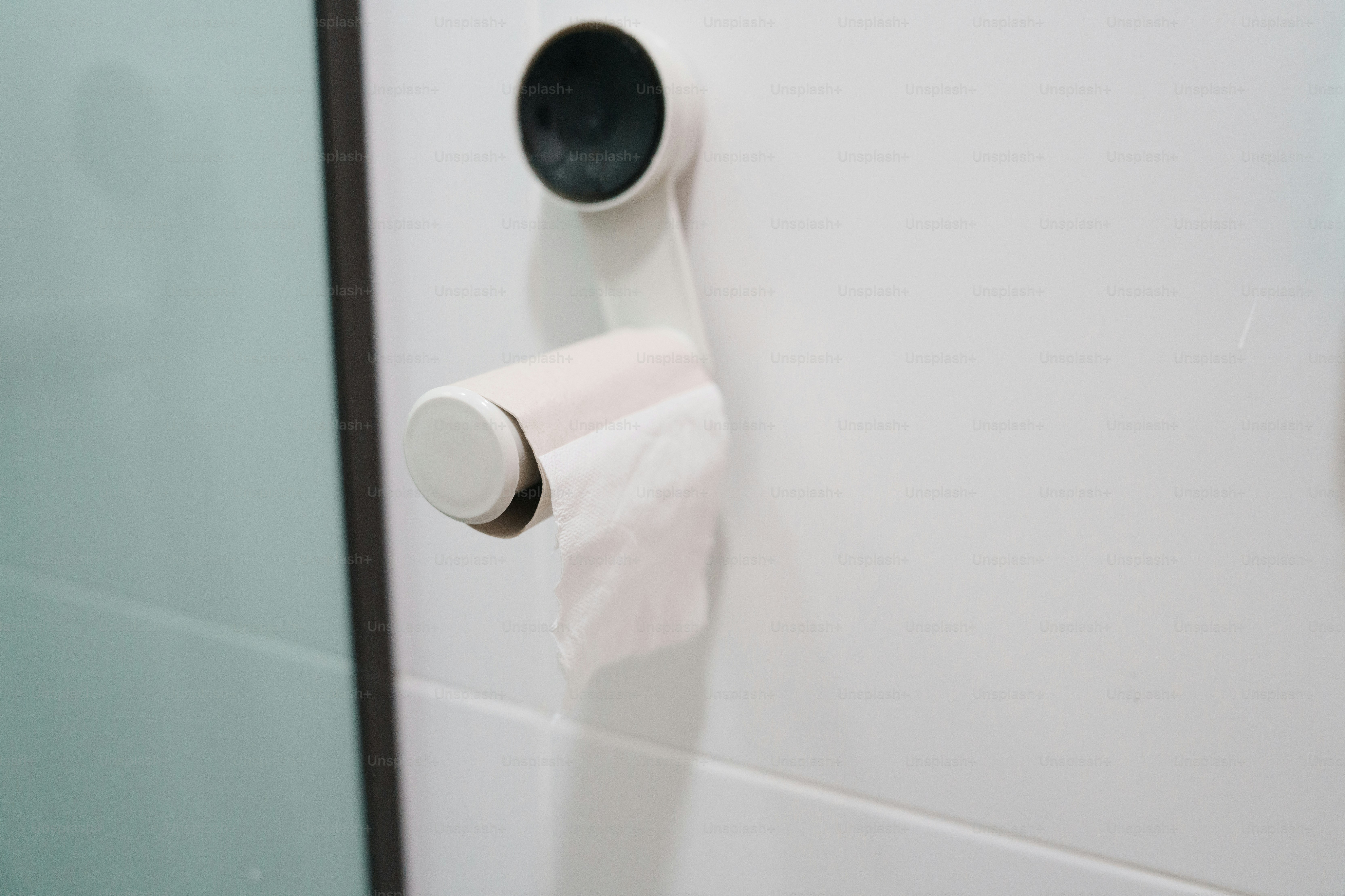 Toilet paper roll holder with minimal paper.