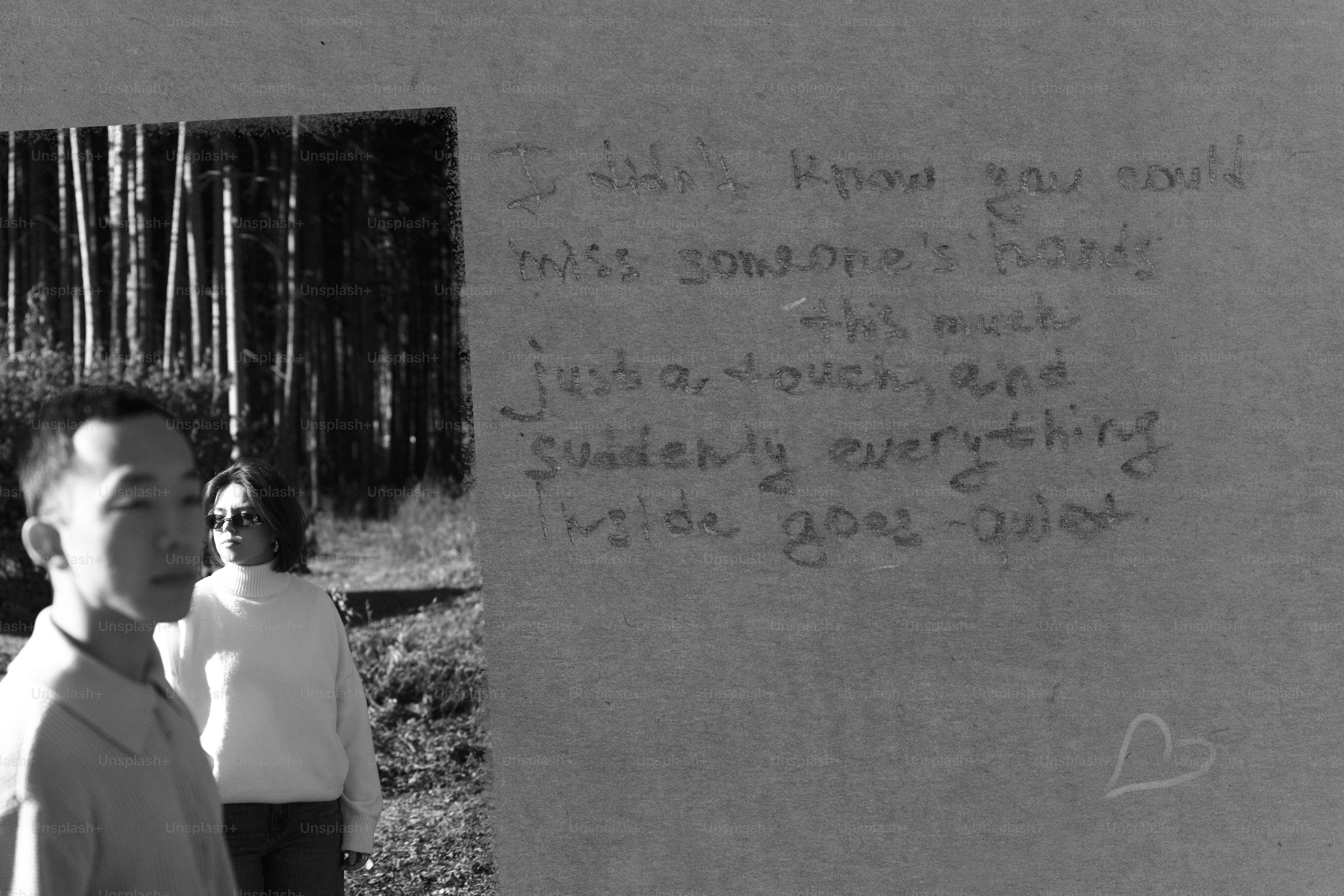 Man and woman near wall with writing