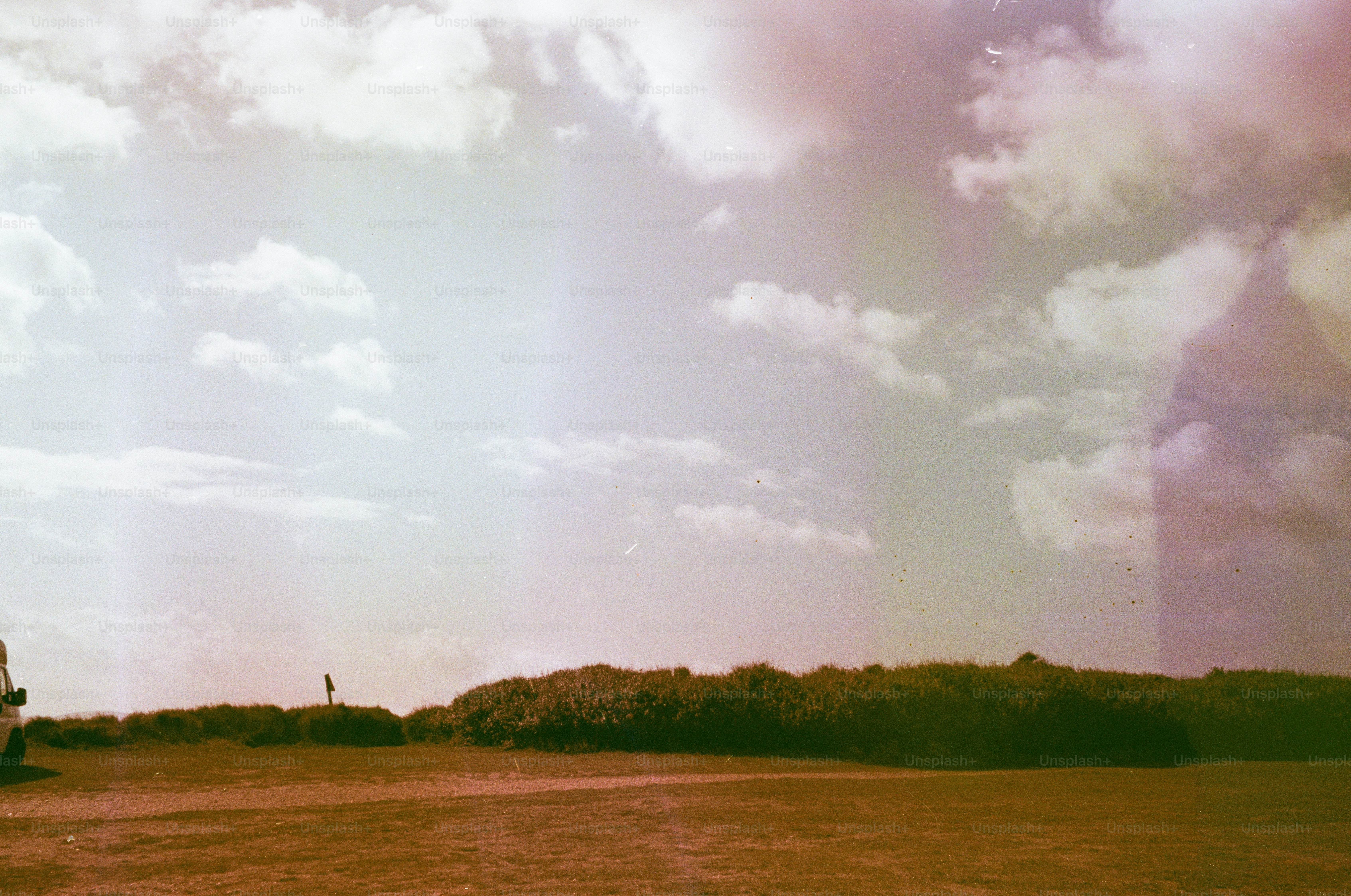Grassy hill with scattered clouds in sky
